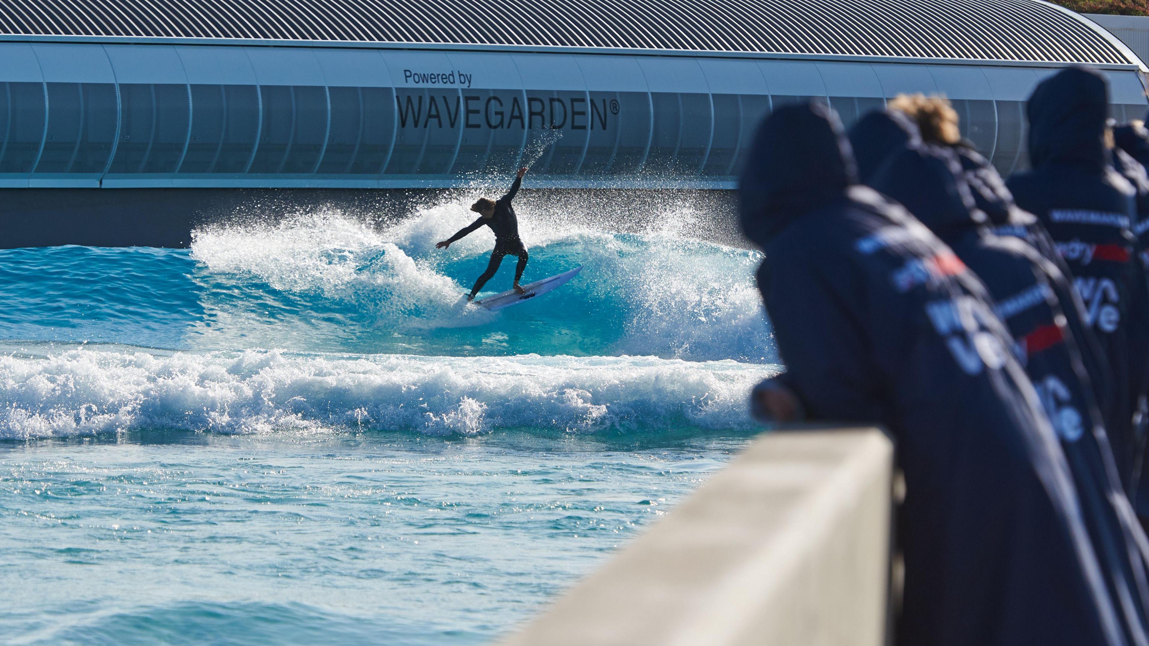 Someone surfing as people watch on