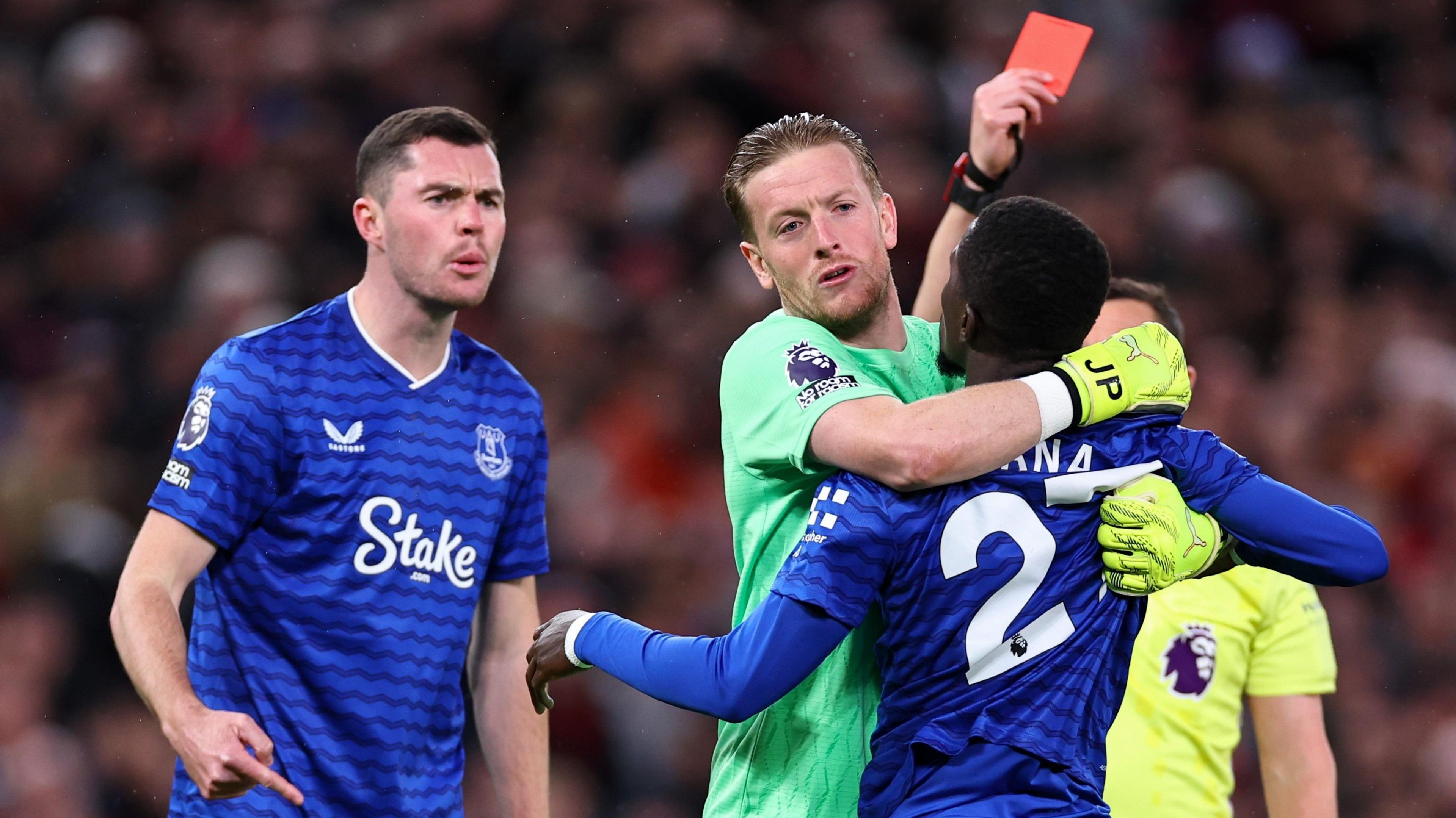 Idrissa Gana Gueye is held back from Michael Keane by Jordan Pickford as the referee shows a red card