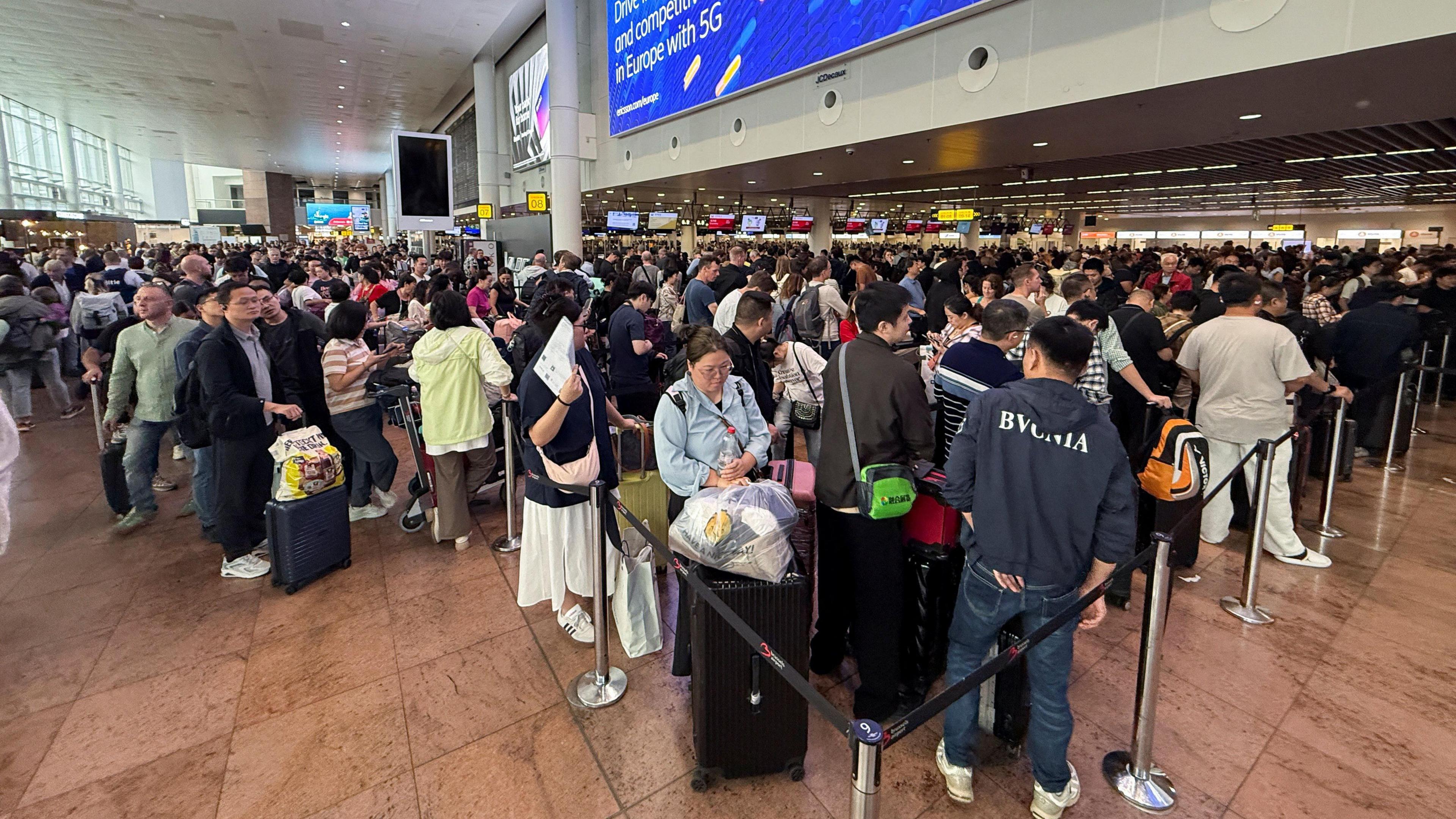Long queues and large crowds seen stretching across the terminal at Brussels Airport on Saturday morning