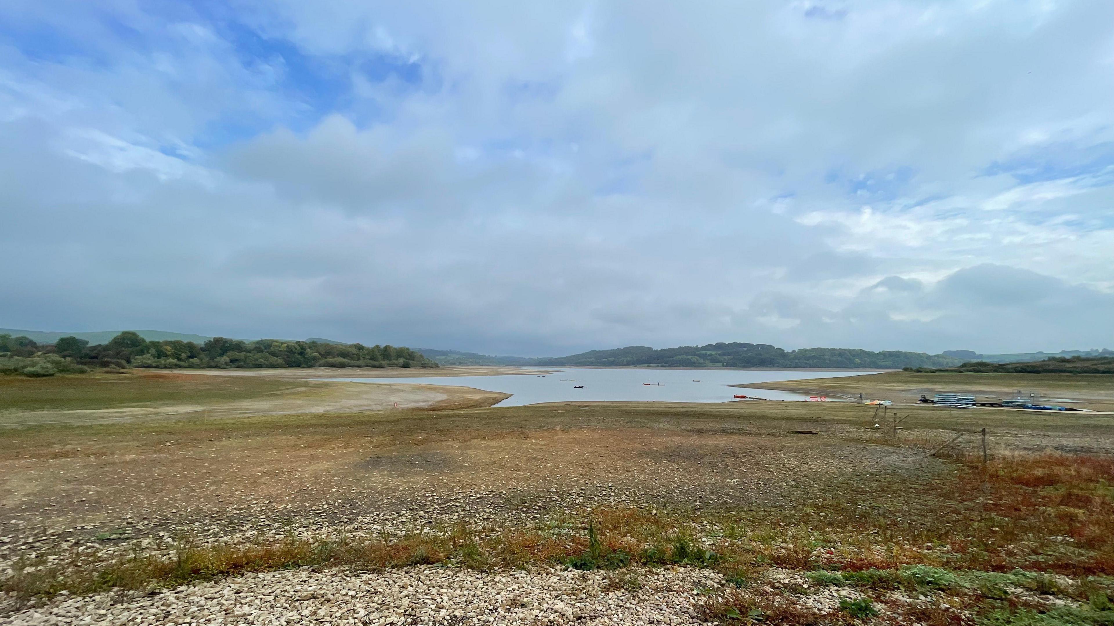 Body of water surrounded by land with grey sky above