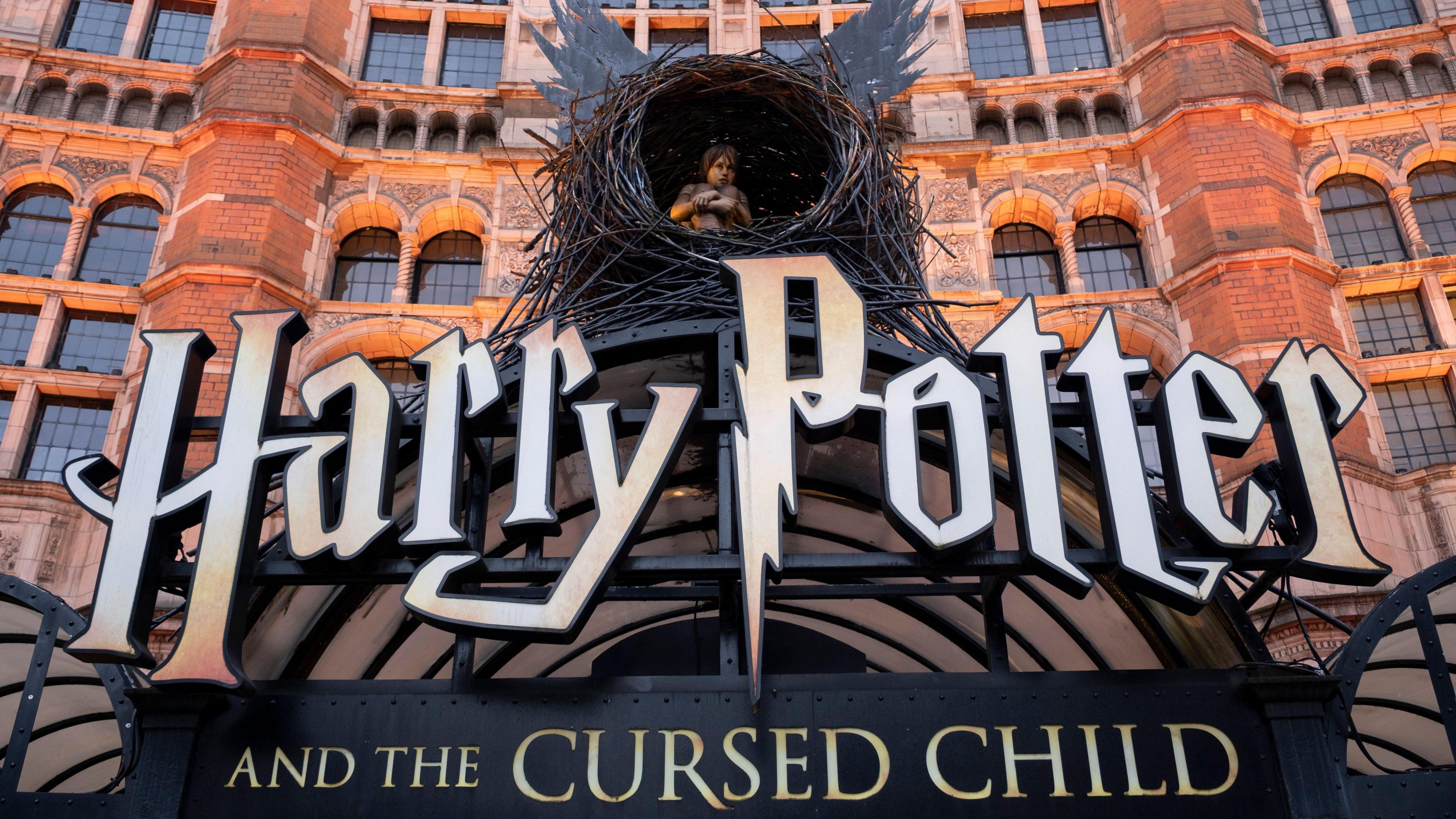  Harry Potter and the Cursed Child sign with biy inside a nest with wings outside a red brick building
