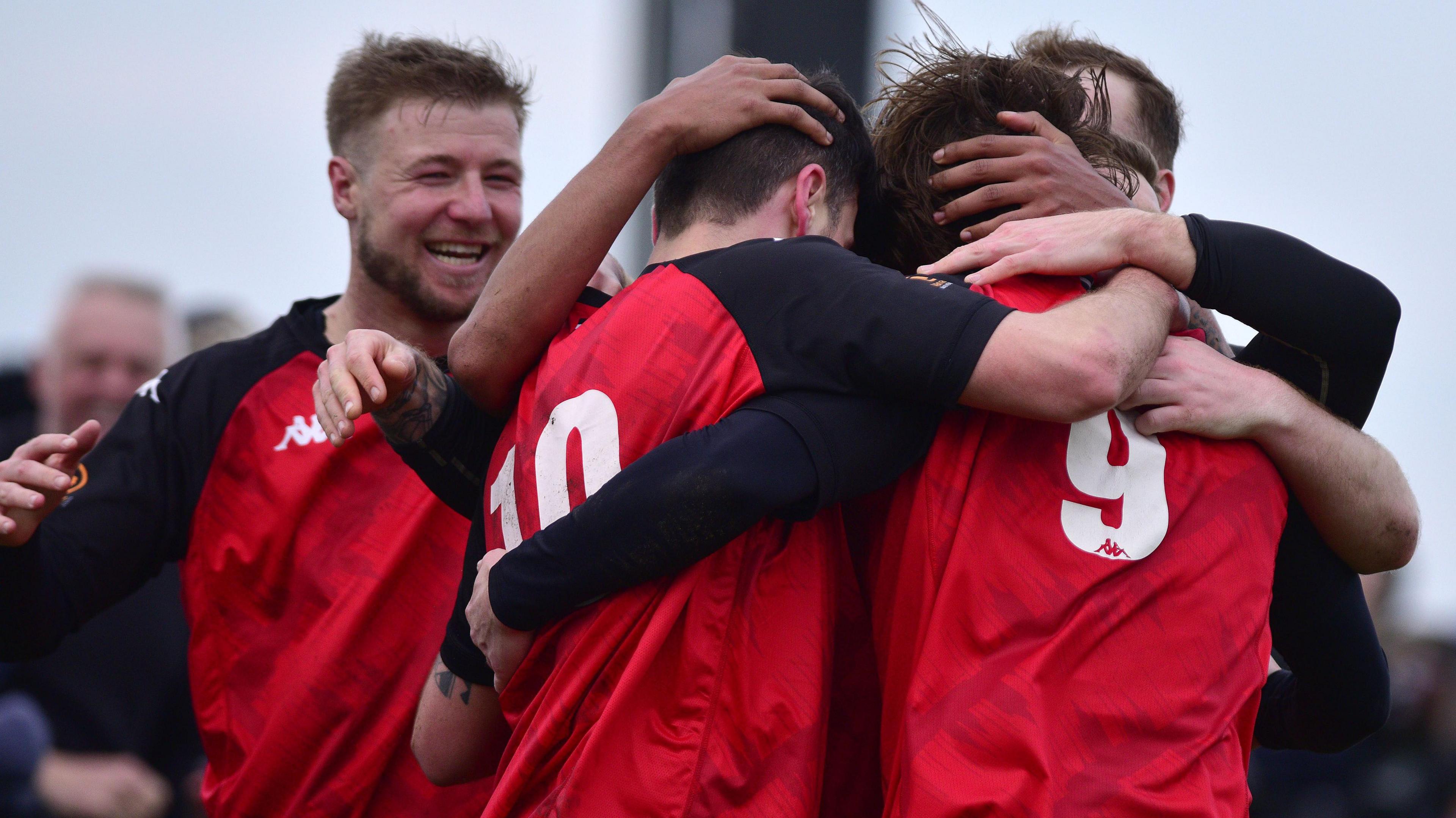 Truro City players celebrate scoring a goal