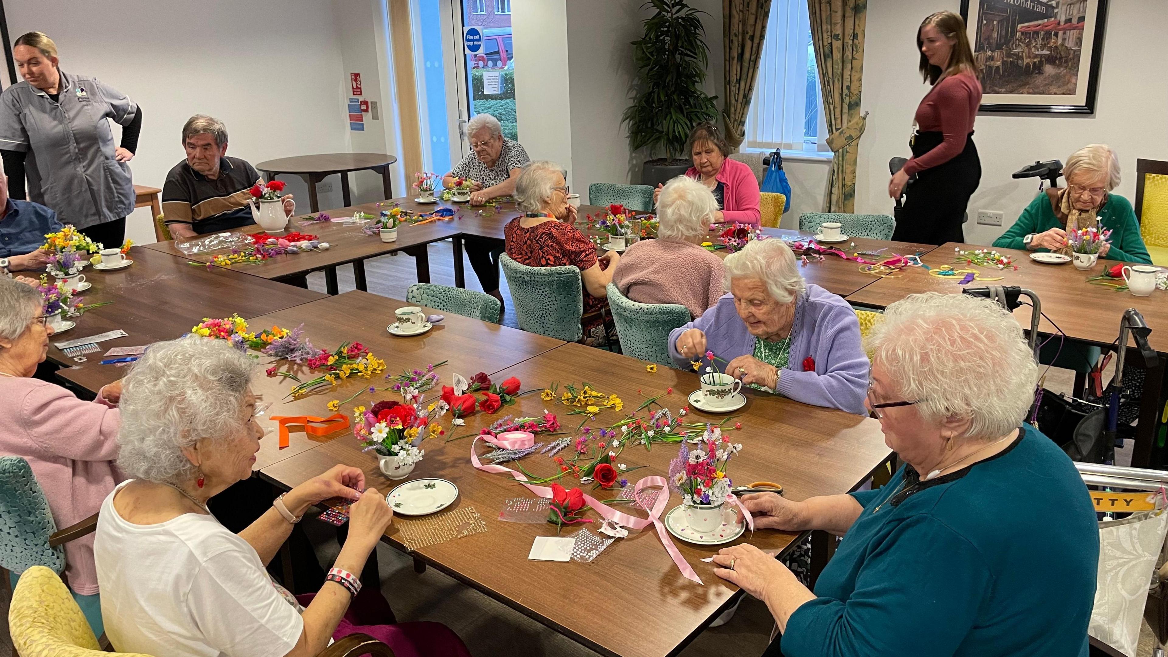 Residents arranging flowers