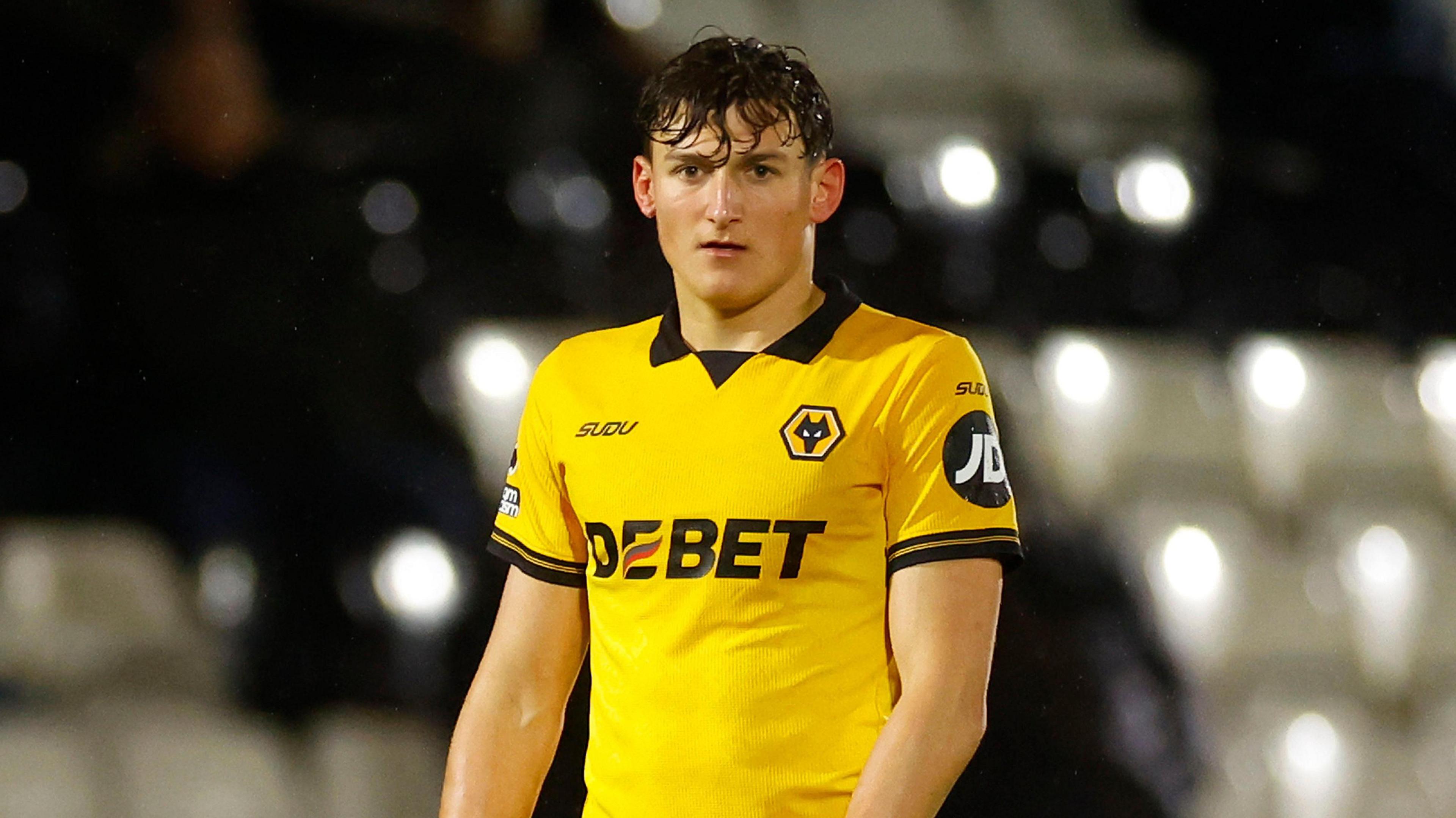 Fletcher Holman standing on the pitch with his arms by his side during a match for Wolves under-21s