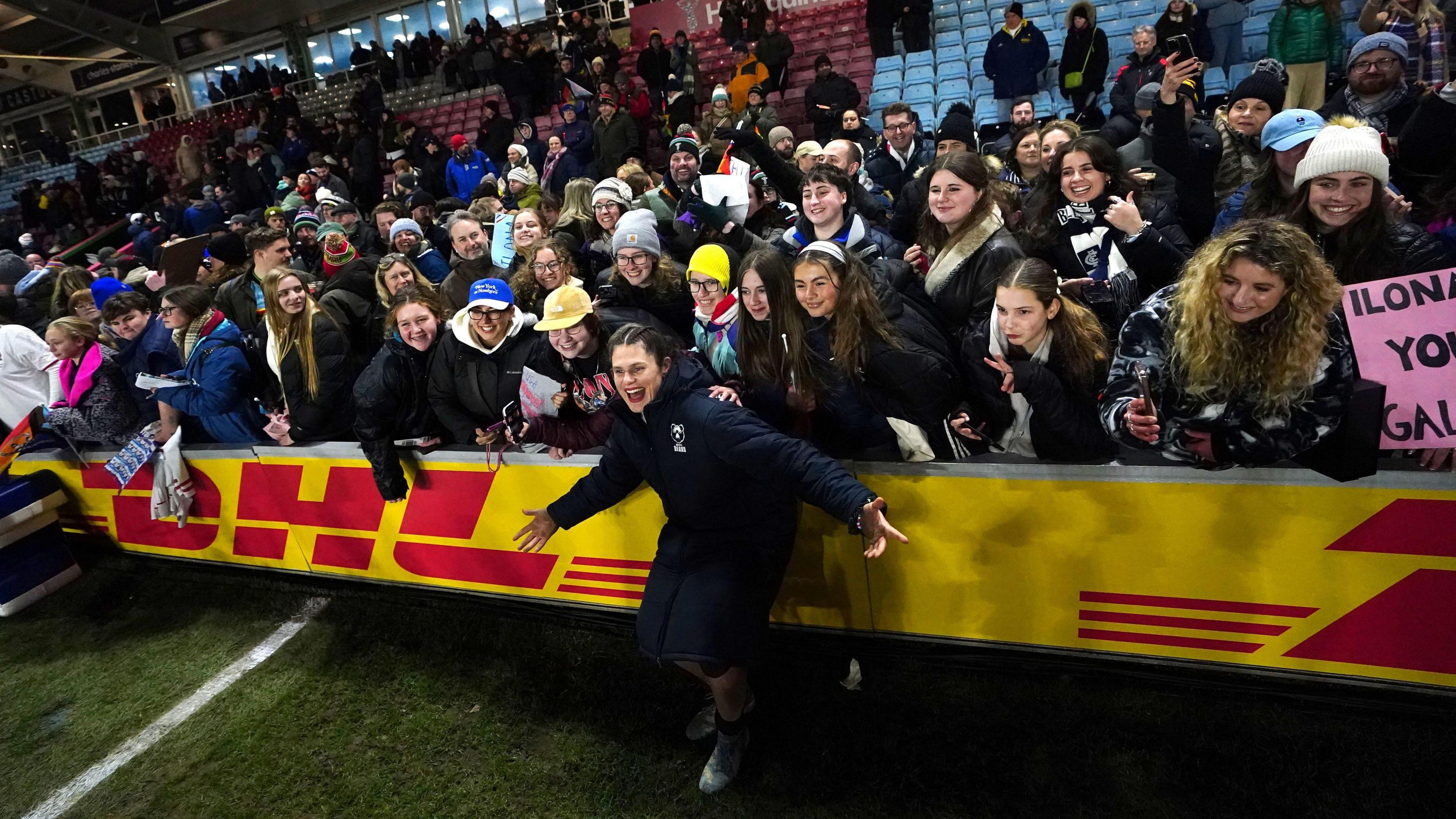 Ilona Maher stands in front of a crowd of fans at the end of a Bristol game this season