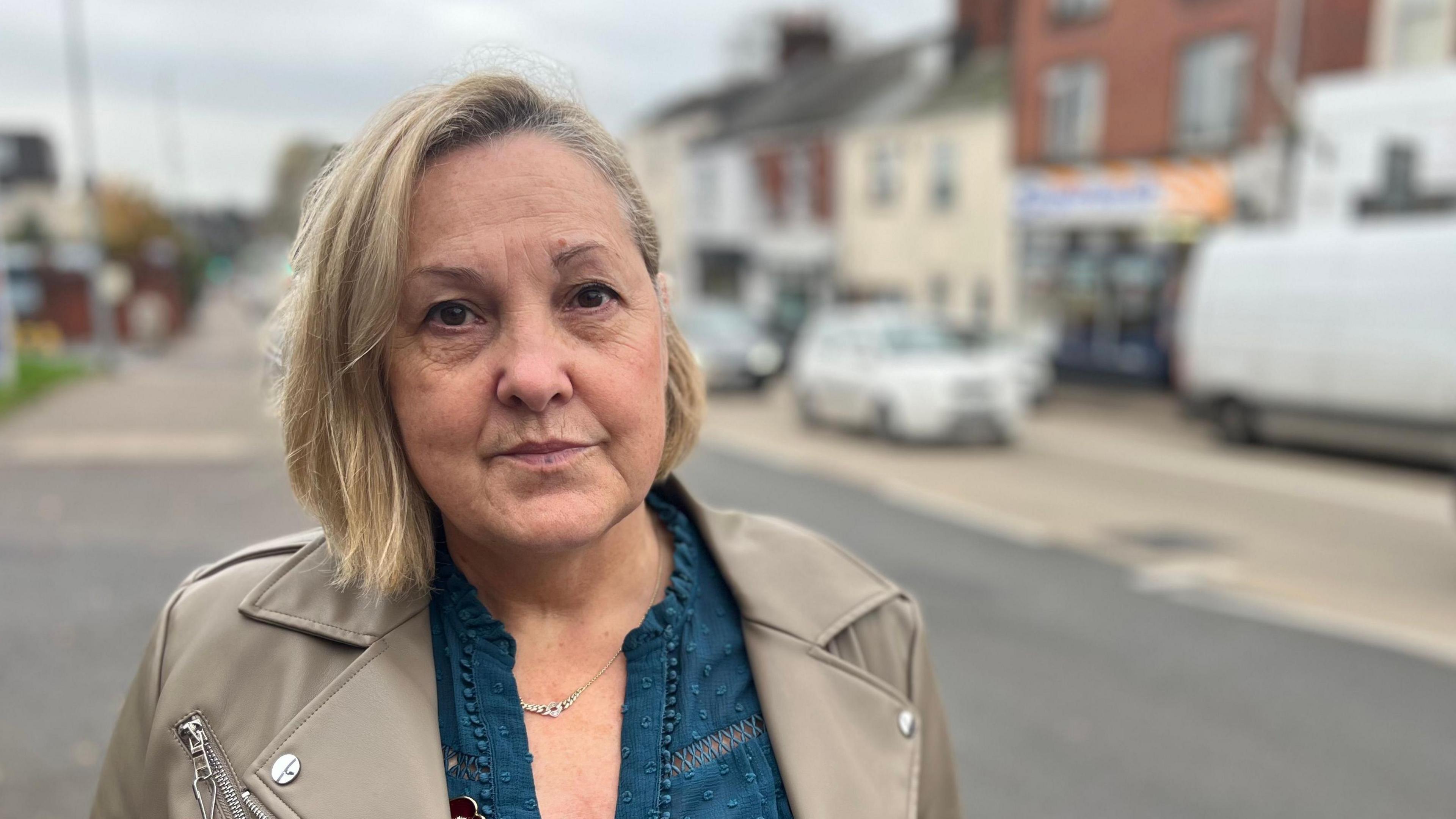 Lyn Burgoyne on Fore Street wearing a blue top and a fawn jacket