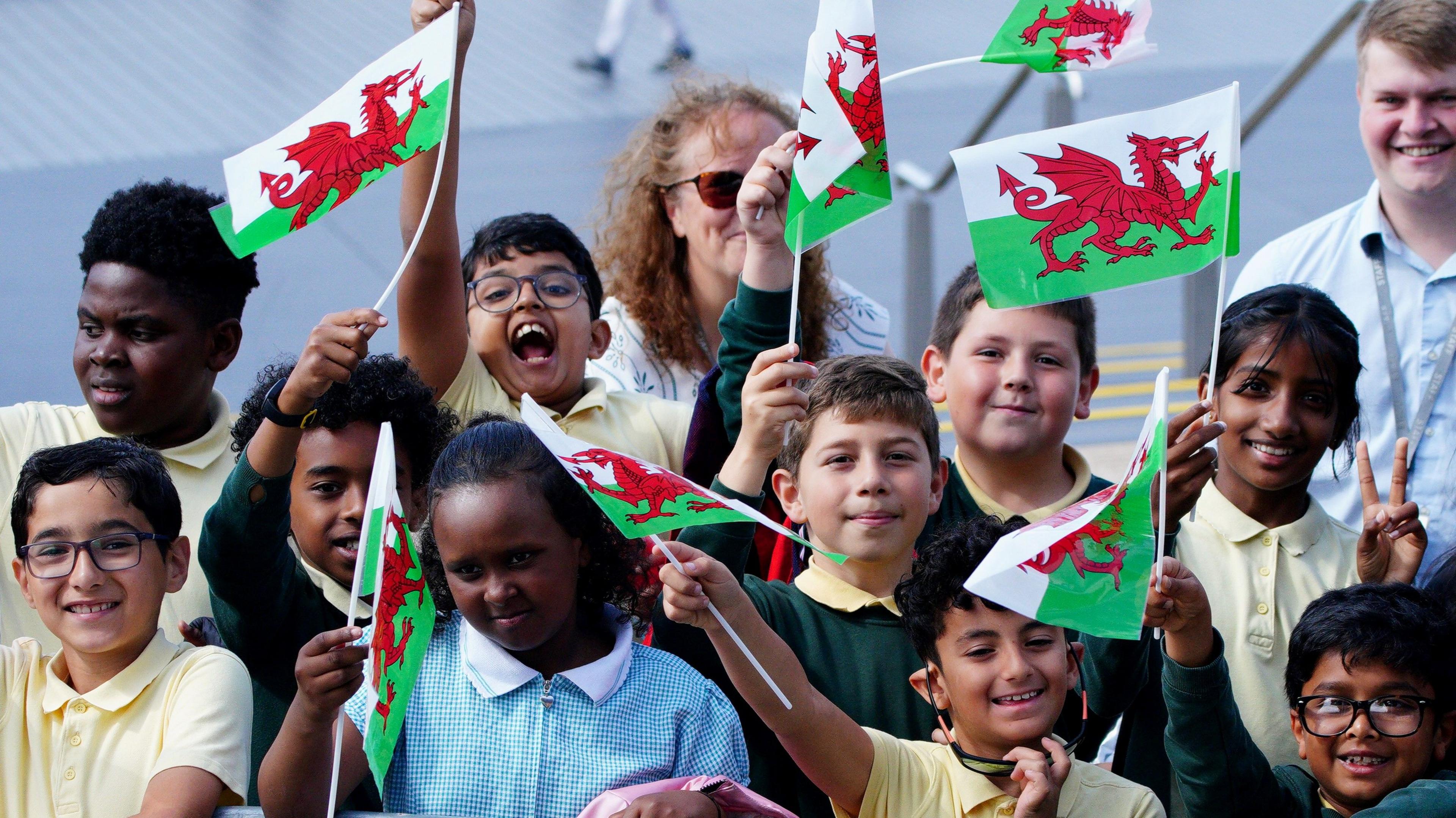Disgyblion ysgol gyda baneri Cymru