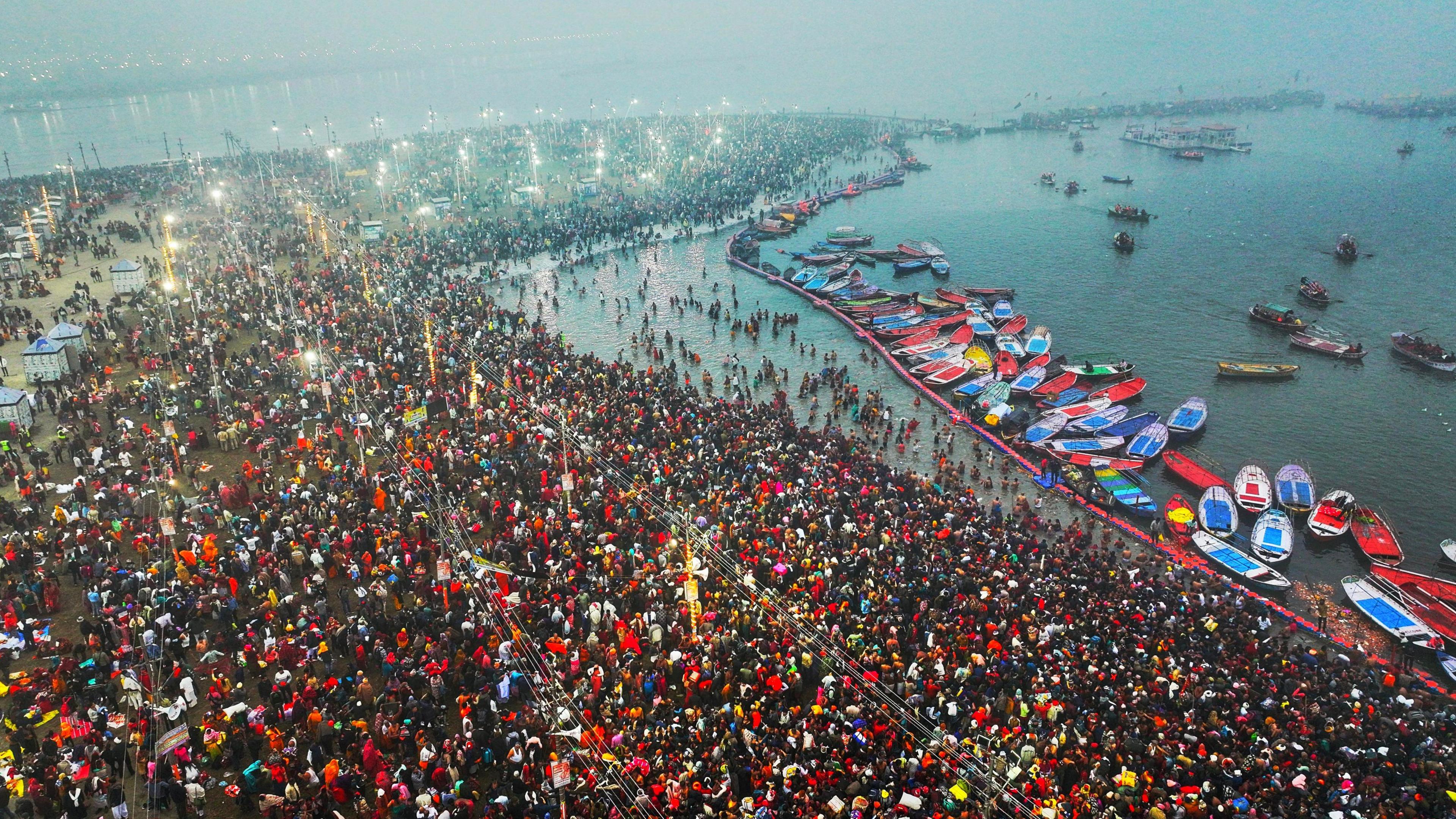 A handout photo taken by drone made available by the Uttar Pradesh State Information Department shows Hindu devotees gathering to take a 'holy bath' on the first day of the Kumbh Mela festival at Sangam, the confluence of the holy rivers Ganges, Yamuna and Saraswati, in Prayagraj, northern state of Uttar Pradesh, India, 13 January 2025. Hundreds of millions of pilgrims are expected to take part in ritual baths at the confluence of India's sacred Ganges river, Yamuna river and the mythical Saraswati during the six-week Hindu festival held every 12 years.