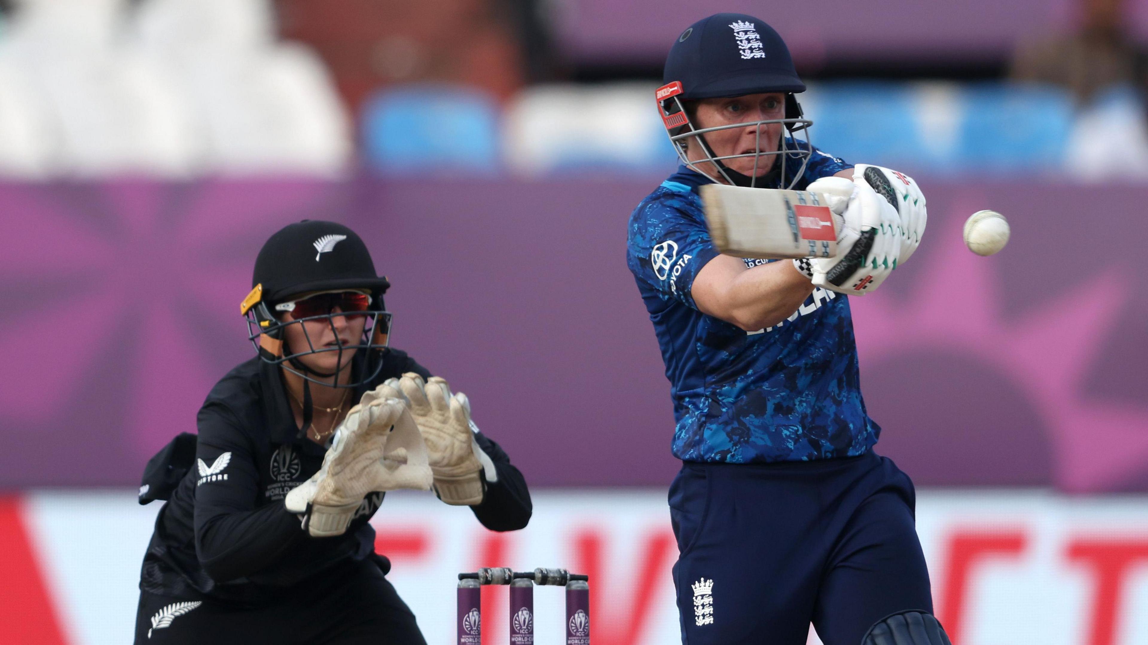 England's Heather Knight plays a shot as New Zealand's Izzy Gaze watches on