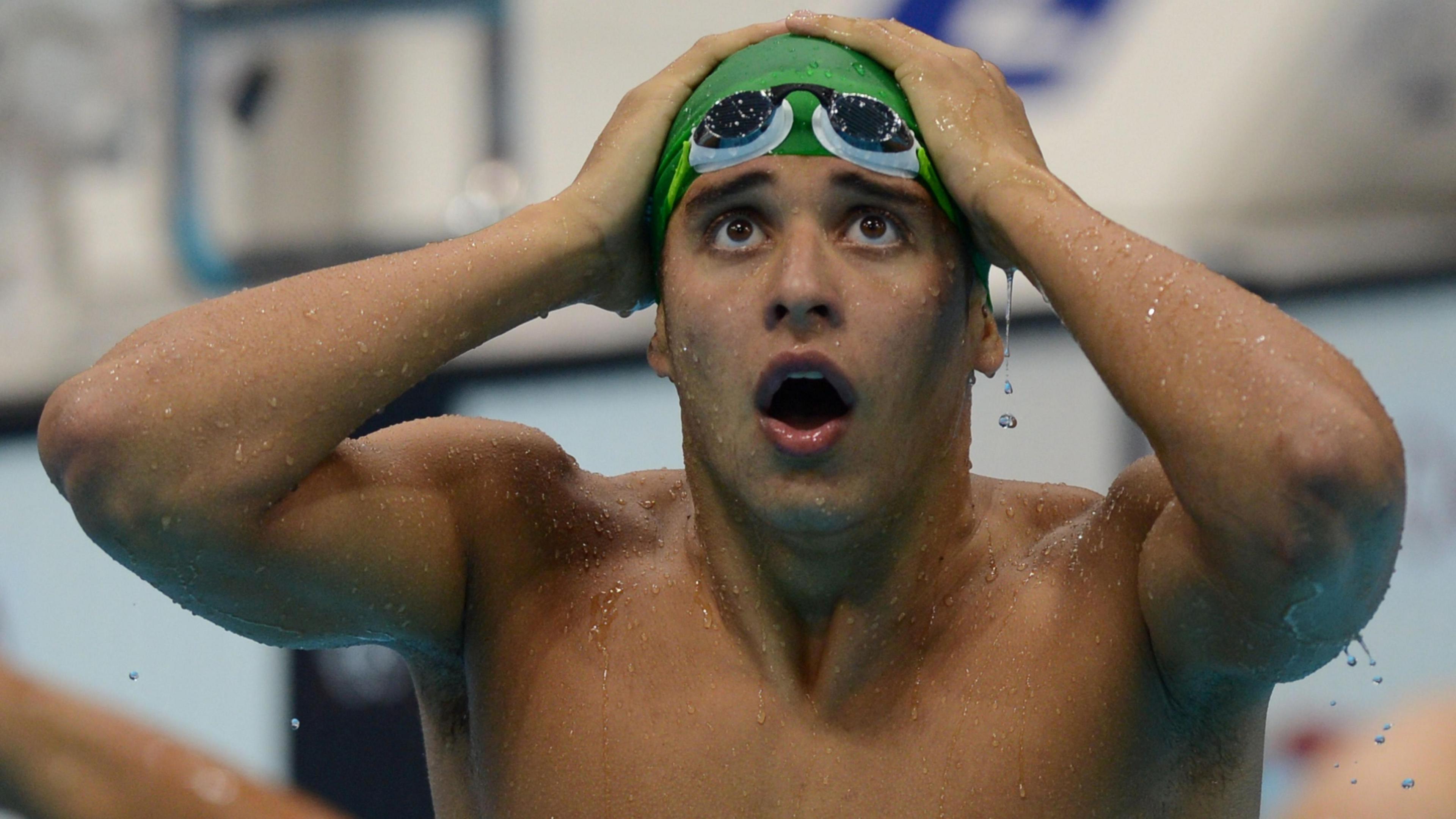A stunned Le Clos - with his hands at his head - realises he has just beaten his hero, Michael Phelps. 