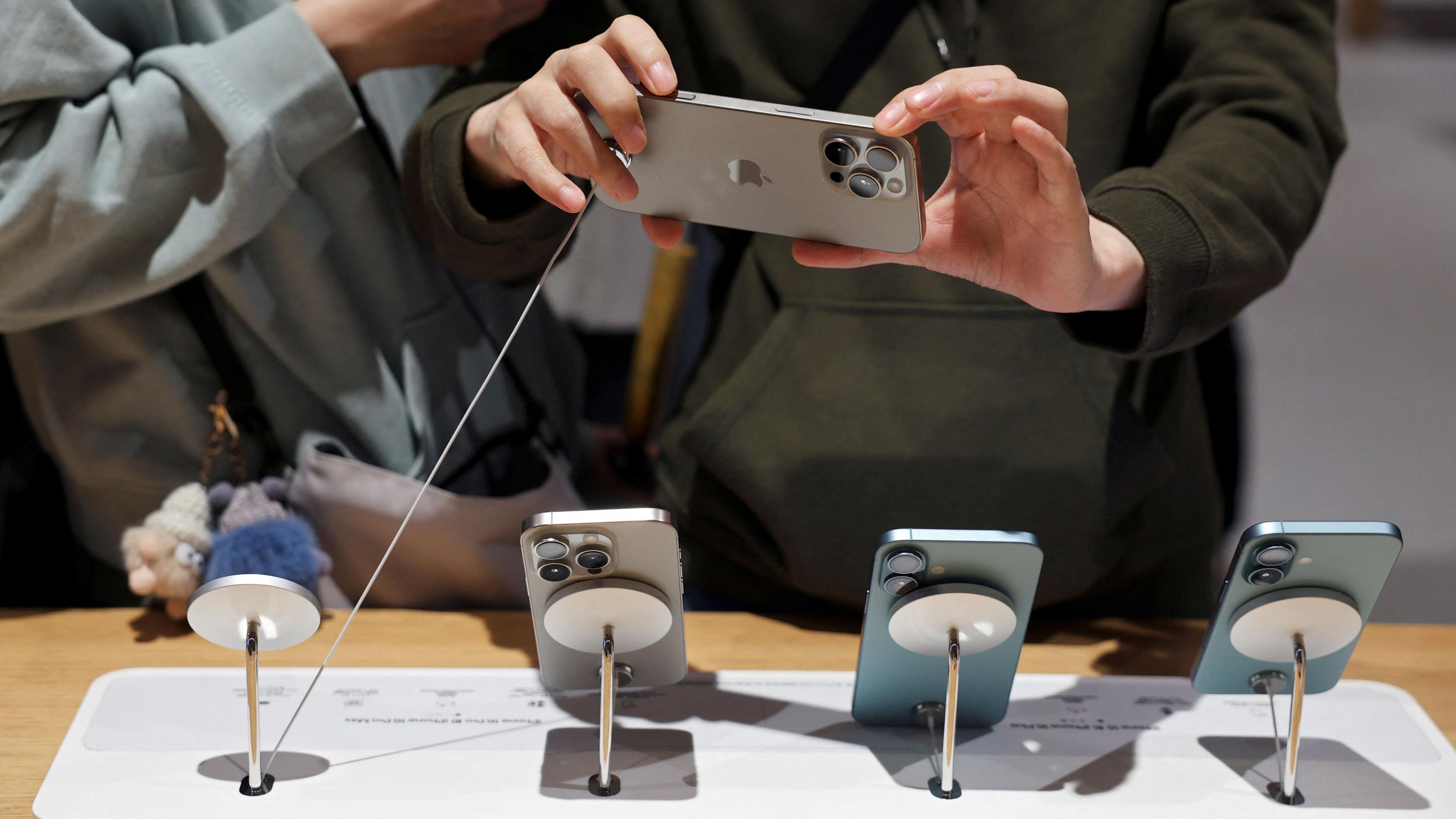 A man checks an iPhone 16 Pro Max as the new iPhone 16 series smartphones go on sale in Beijing.