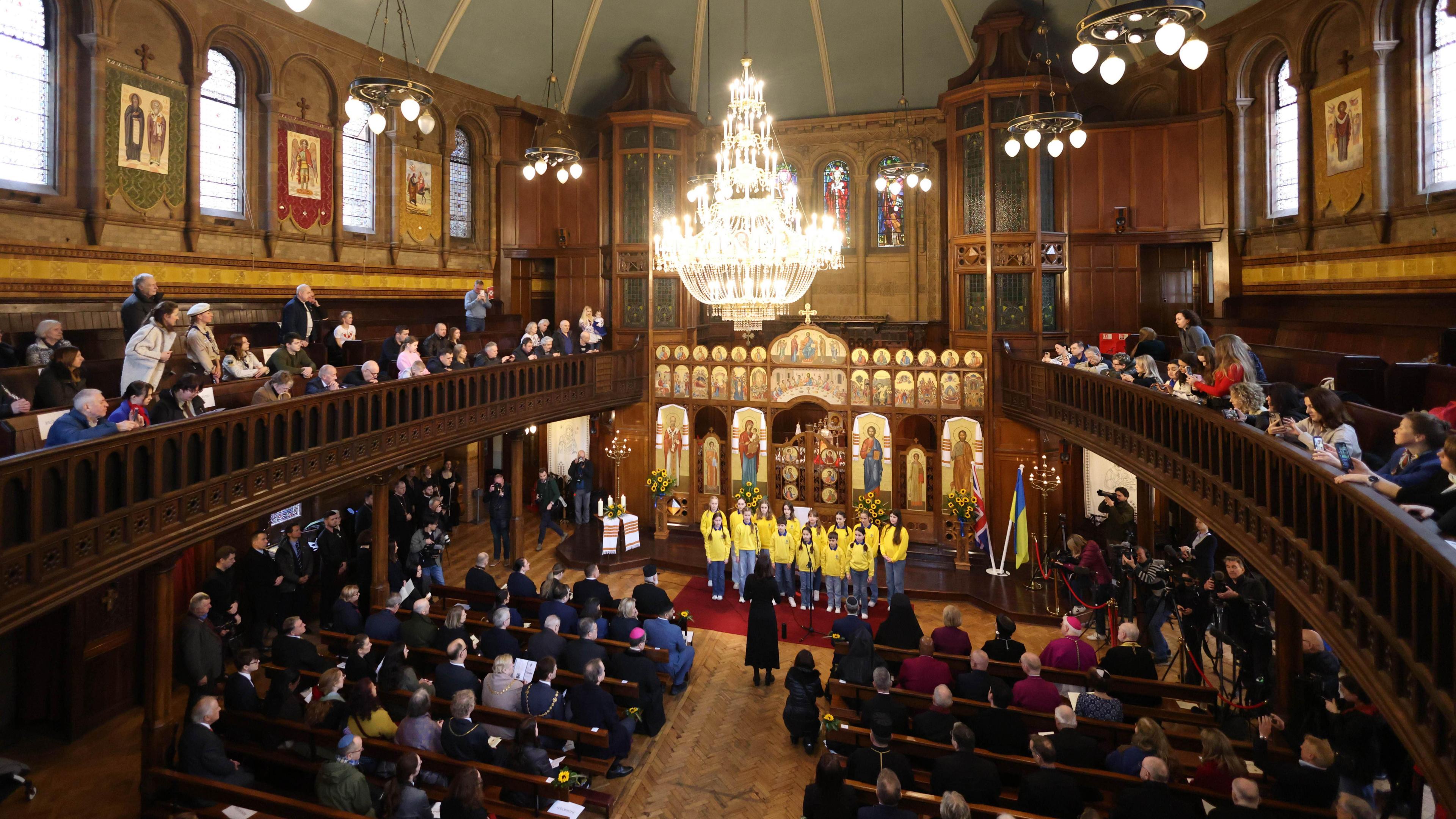 Children from St Mary's Ukrainian School sing during an interfaith prayer service for peace in Ukraine at the Ukrainian Catholic Cathedral.