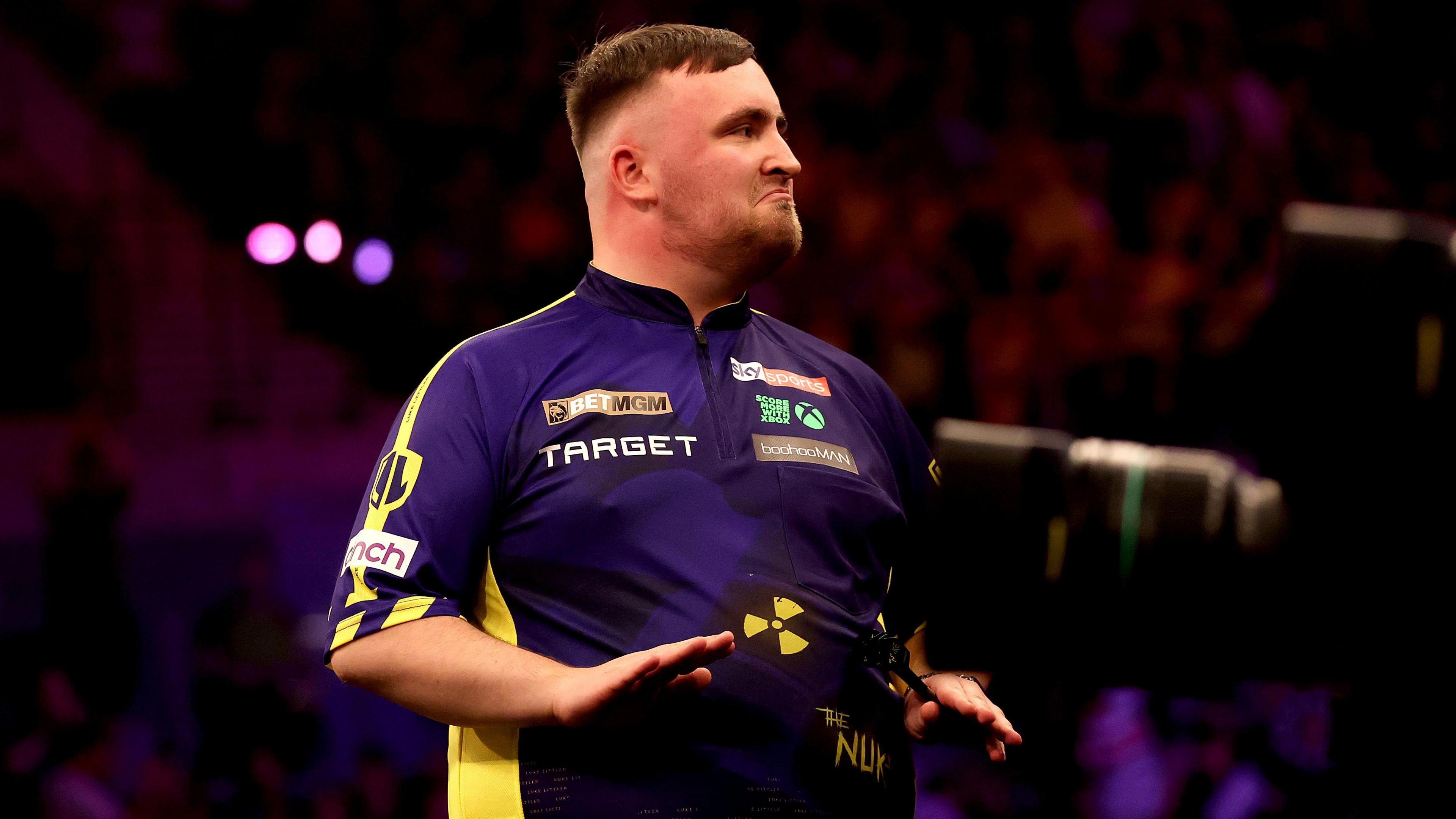 Luke Littler gestures to the Liverpool crowd to calm down during the 2025 Premier League Darts