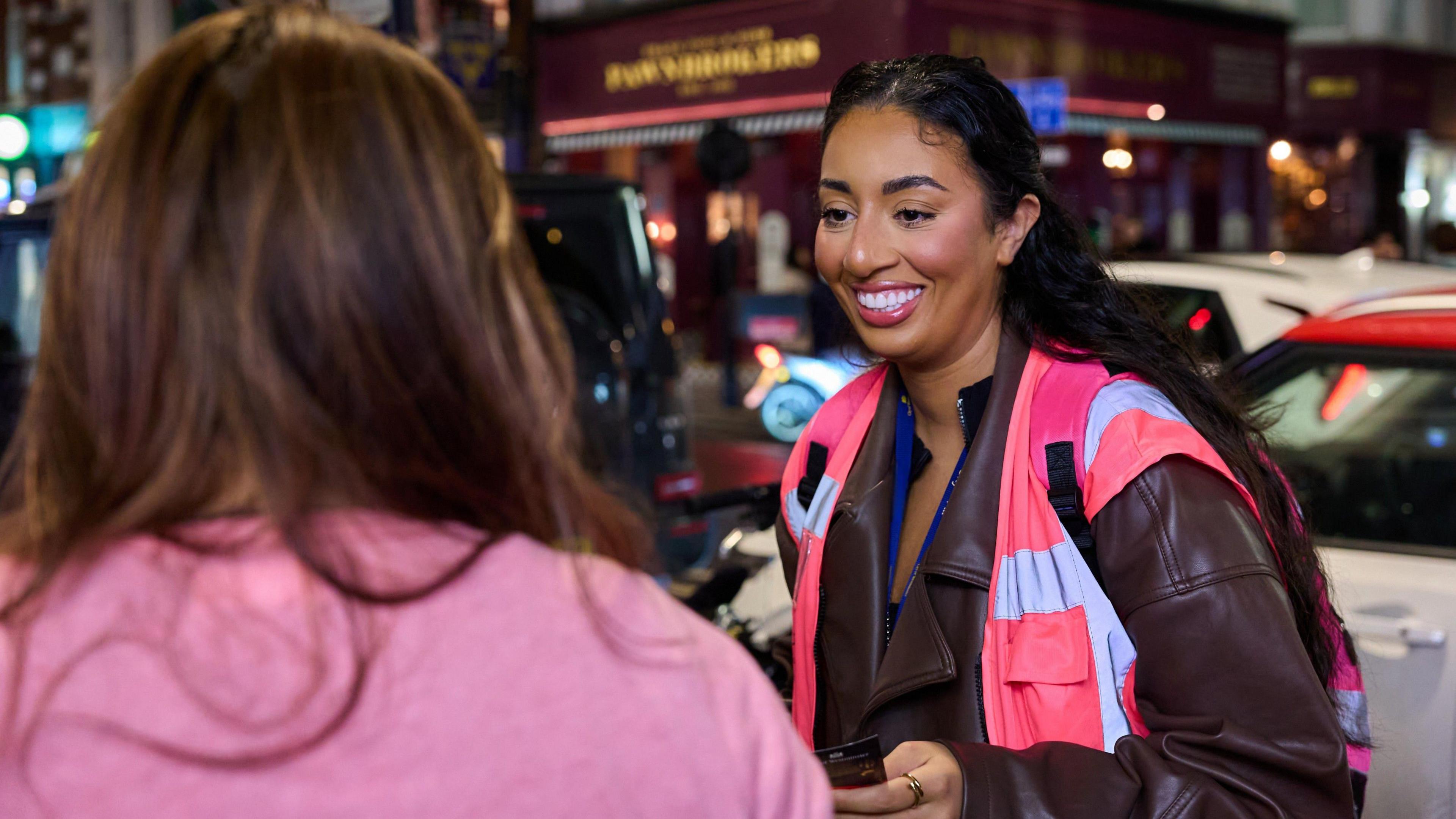 Councillor Iman Less talking to a woman on a night out