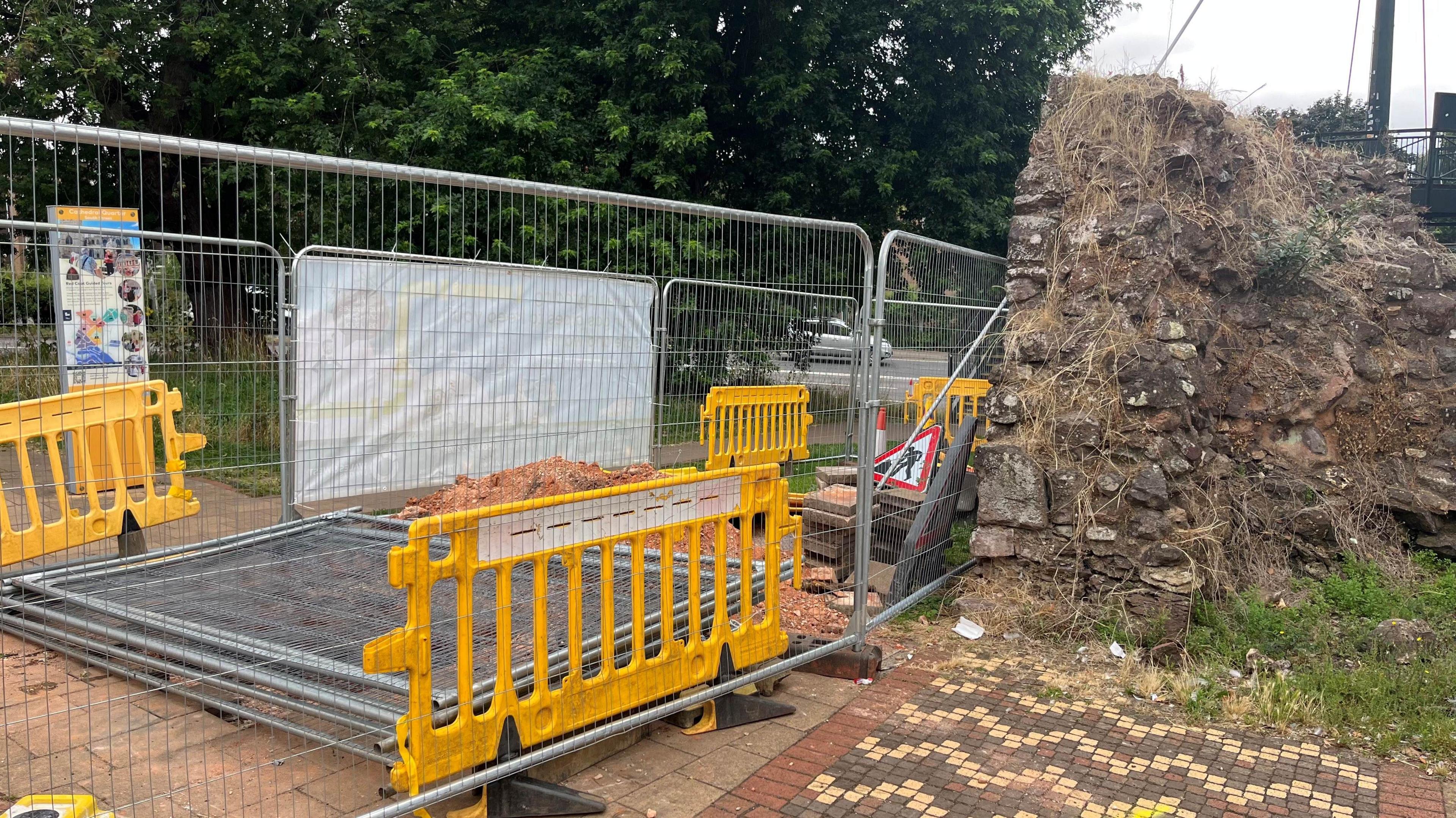 The site of the works with barricades up next to Exeter's Roman wall