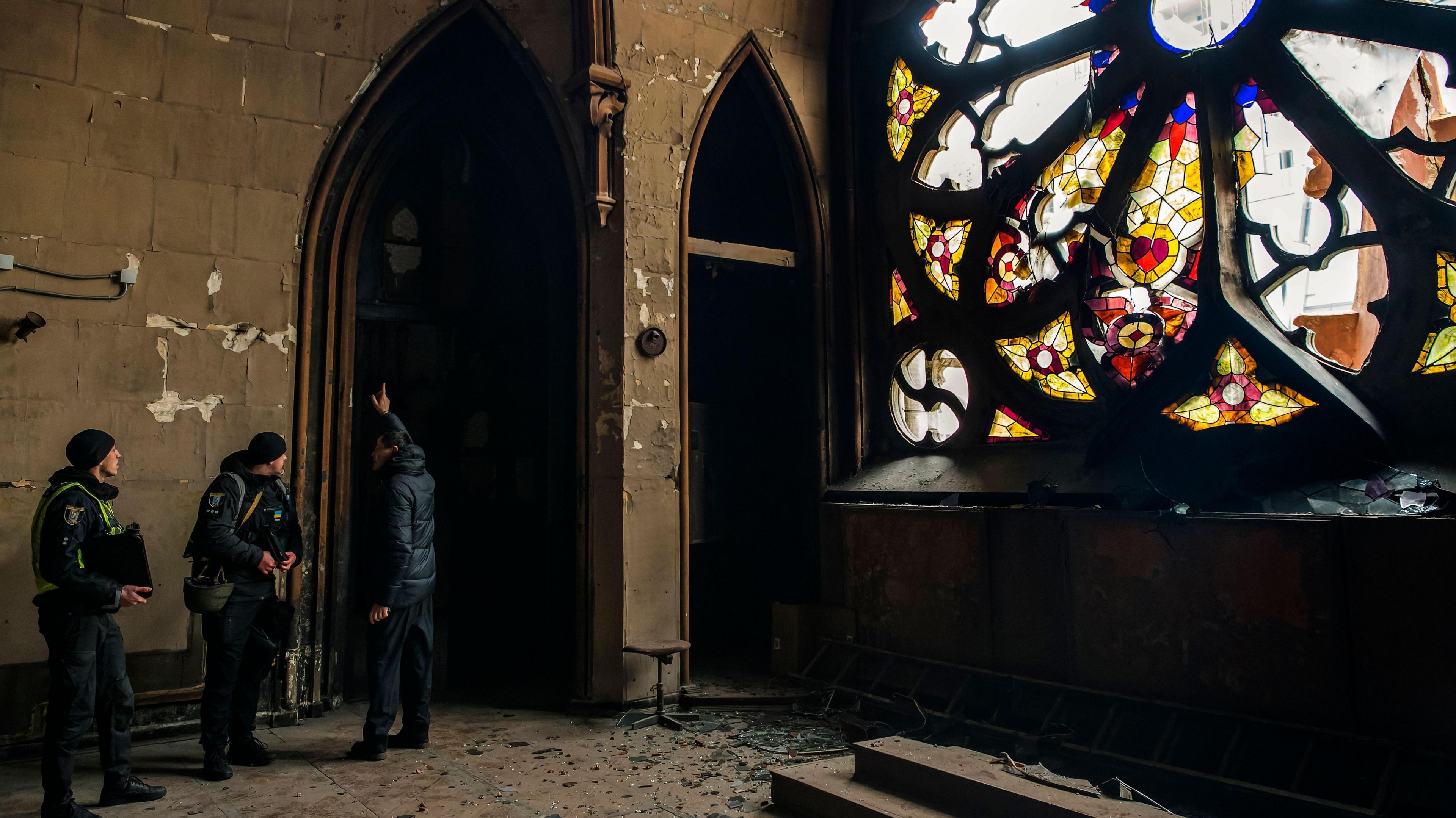 Police inspect debris inside the St. Nicholas Roman Catholic Church in Kyiv