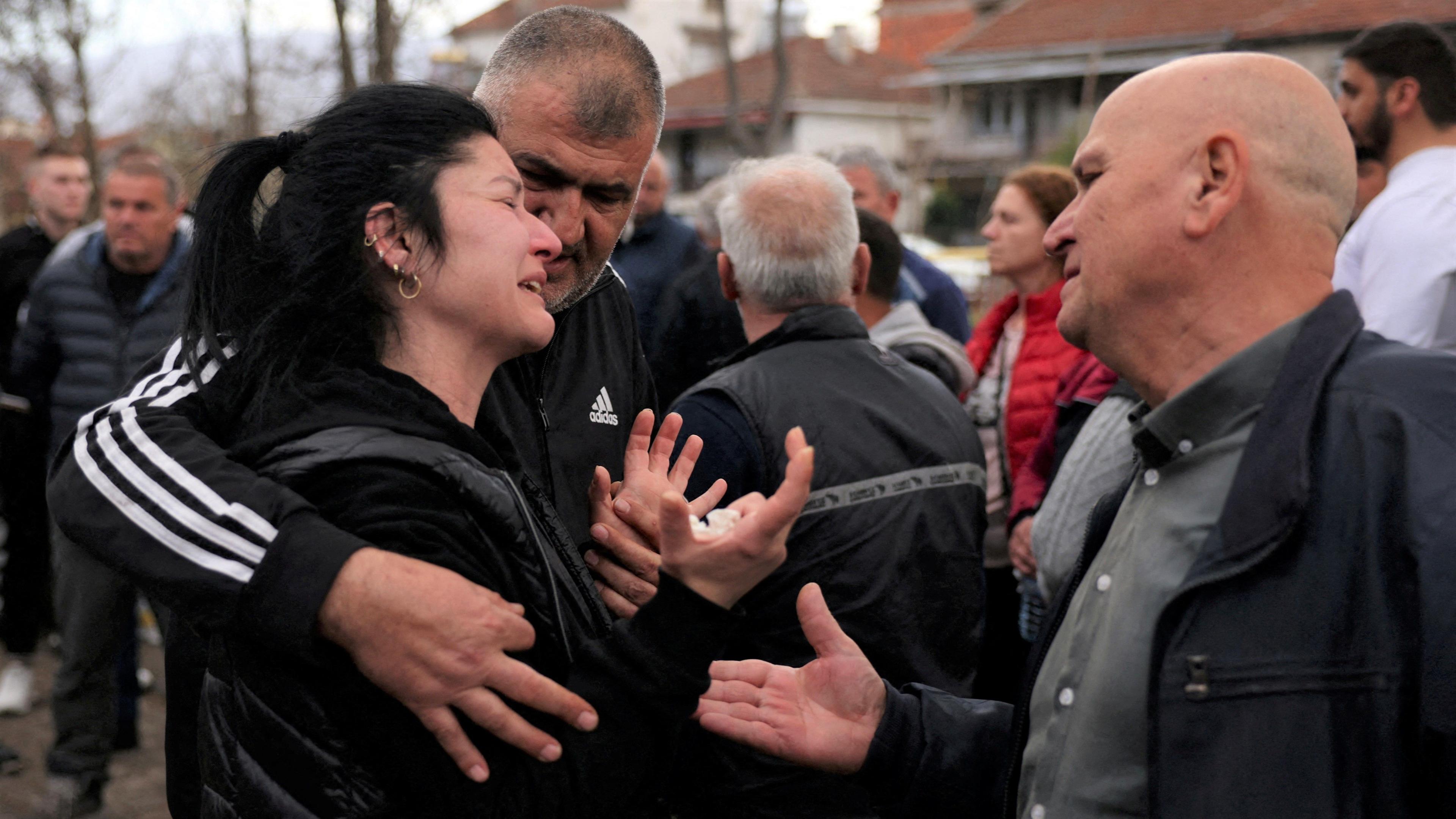 People react outside a hospital, following a fire in a night club resulting in casualties, in the town of Kocani, North Macedonia, March 16, 2025.