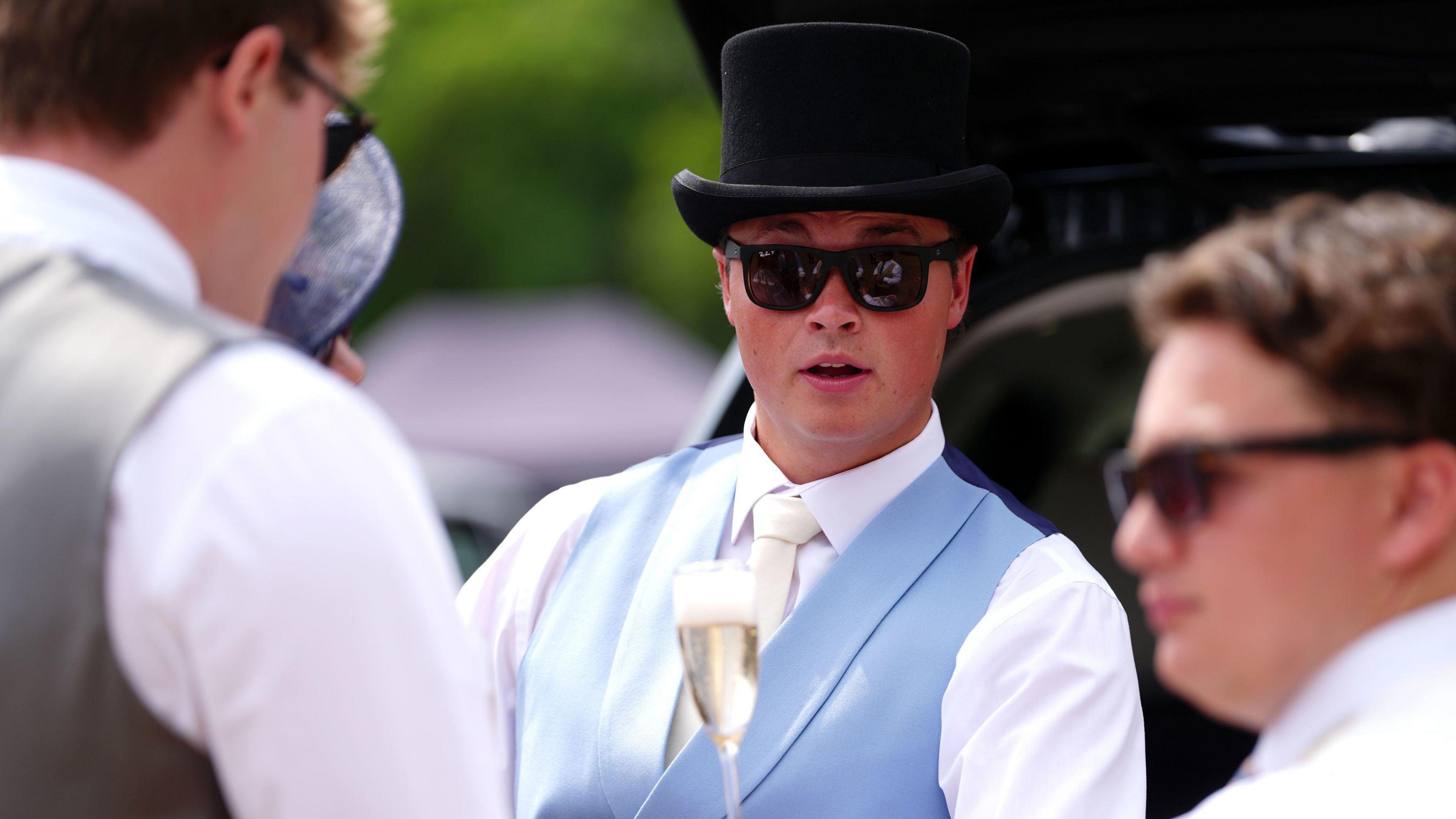 Racegoers have a drink in the shade on day four of Royal Ascot at Ascot Racecourse. 