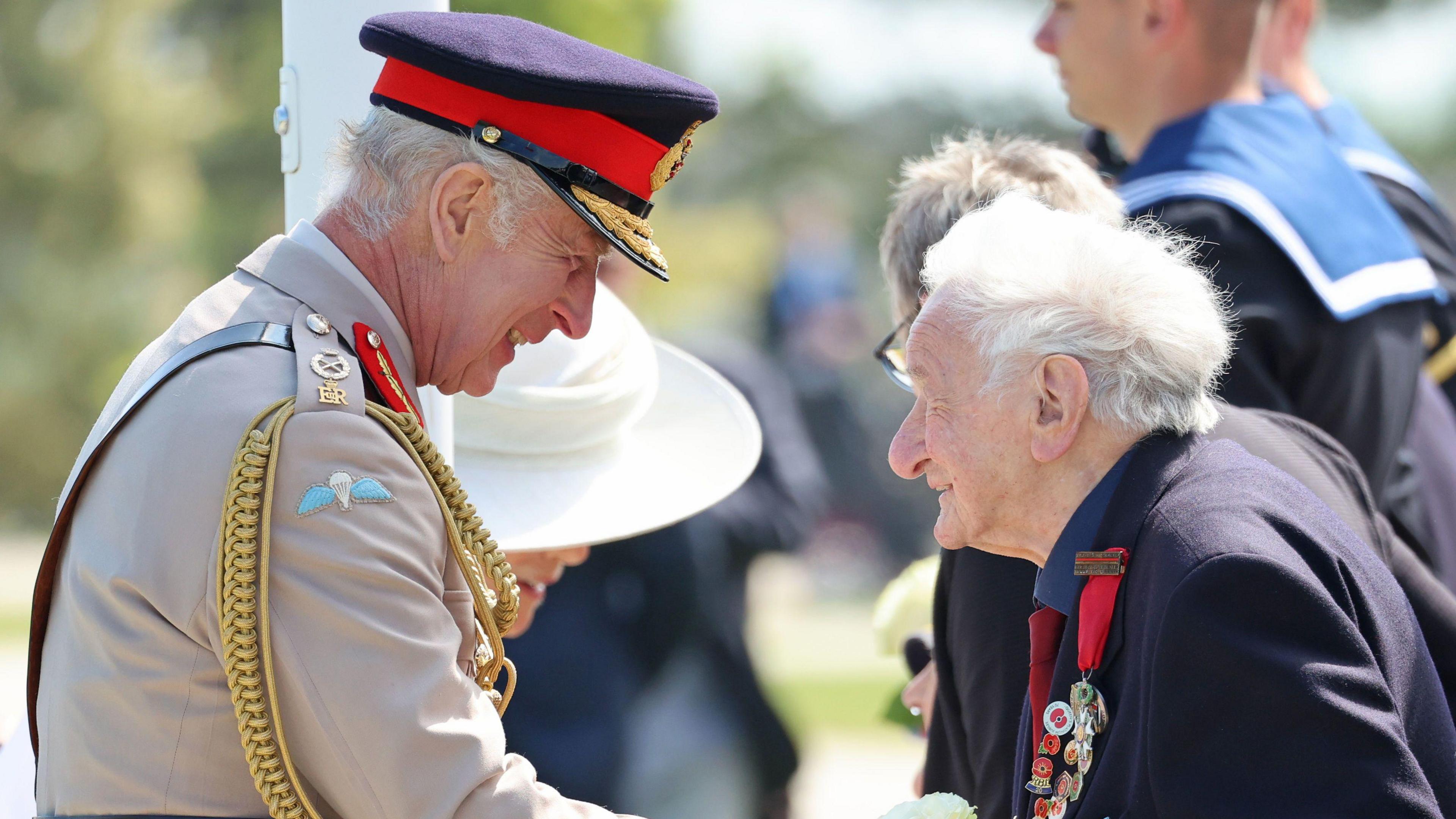 The King shaking the hand of a 99-year-old veteran