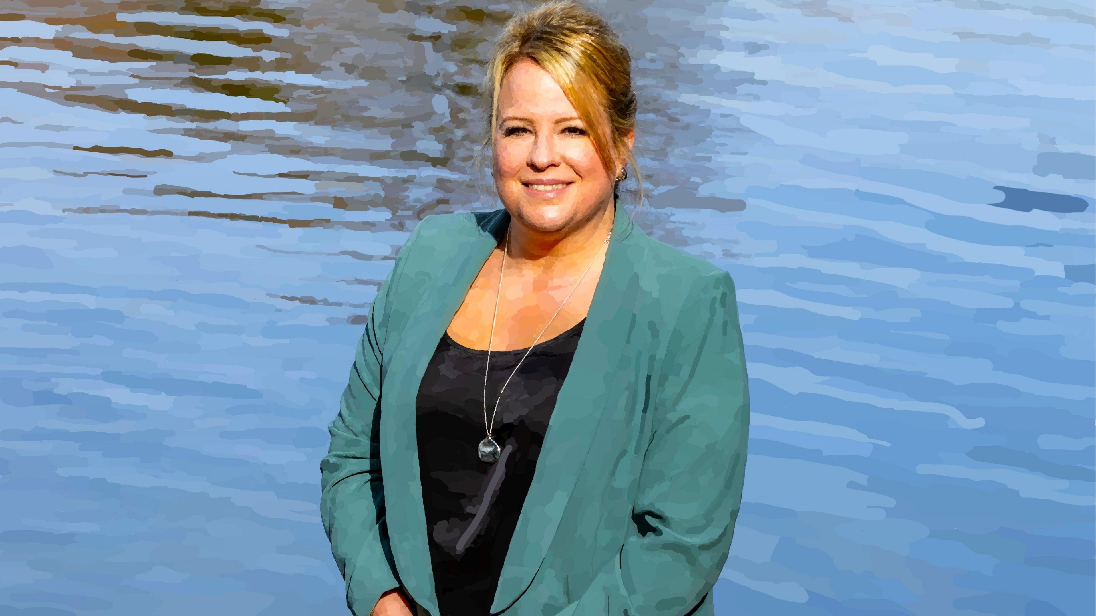 A digital art image of Sharon Livermore by Holly Ringrose, showing Sharon, smiling to the camera, with her blonde hair up, wearing a long necklace, black top and green jacket