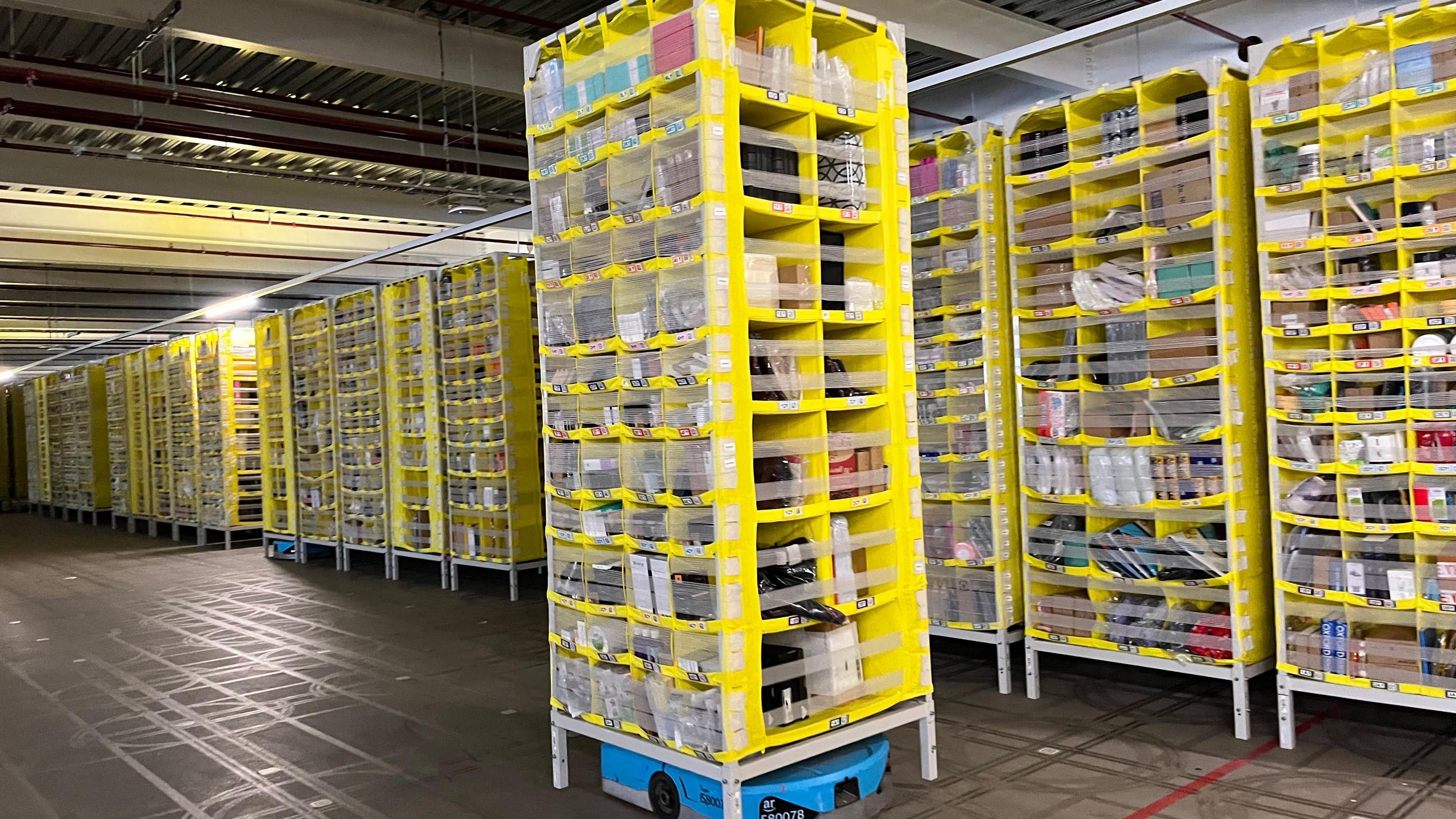 A large yellow Hercules Drive robot moving goods around Amazon's LCY3 depot in Dartford.