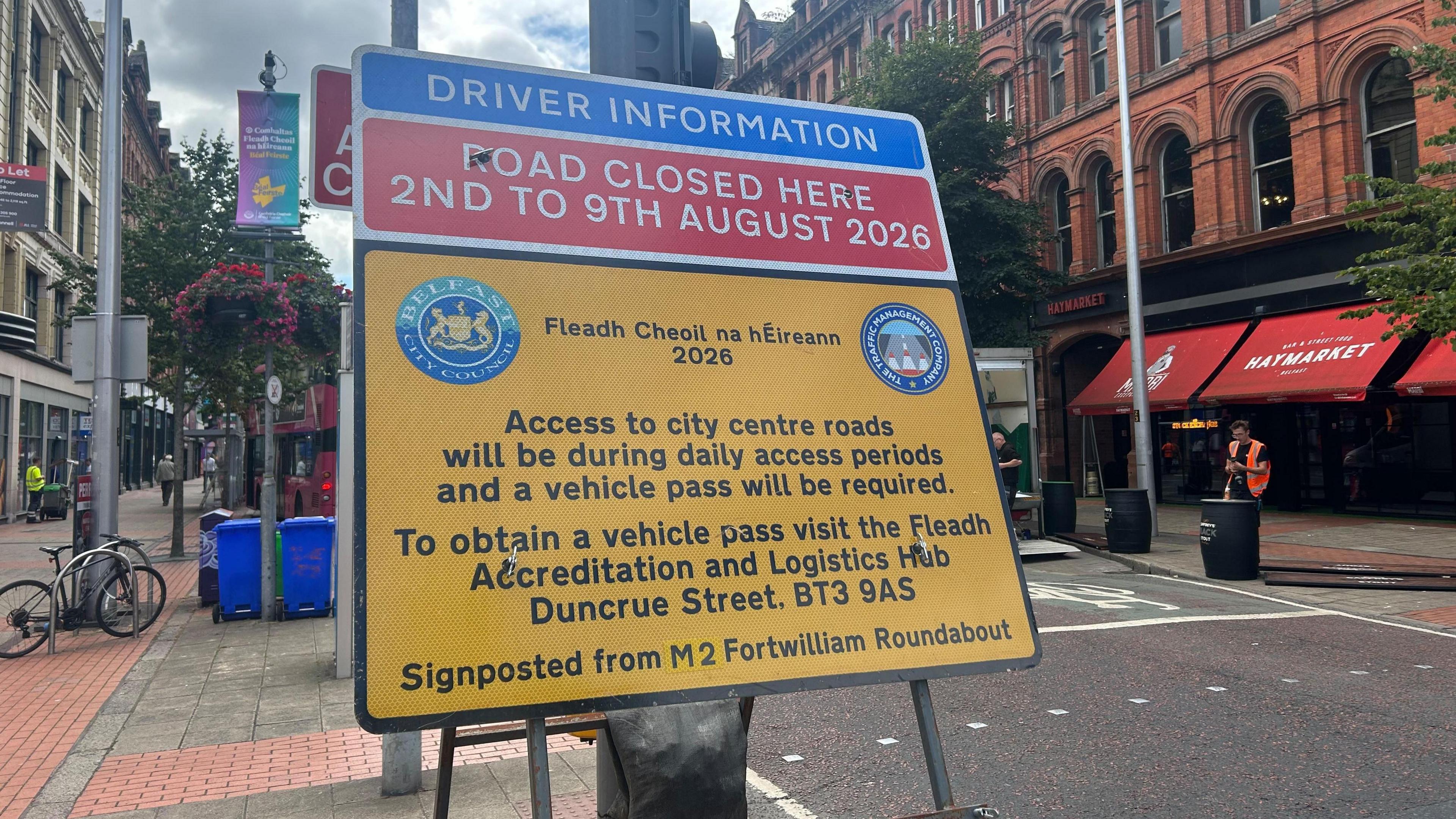 A red and yellow Belfast City Council sign outlining road closures in the city during the Fleadh.