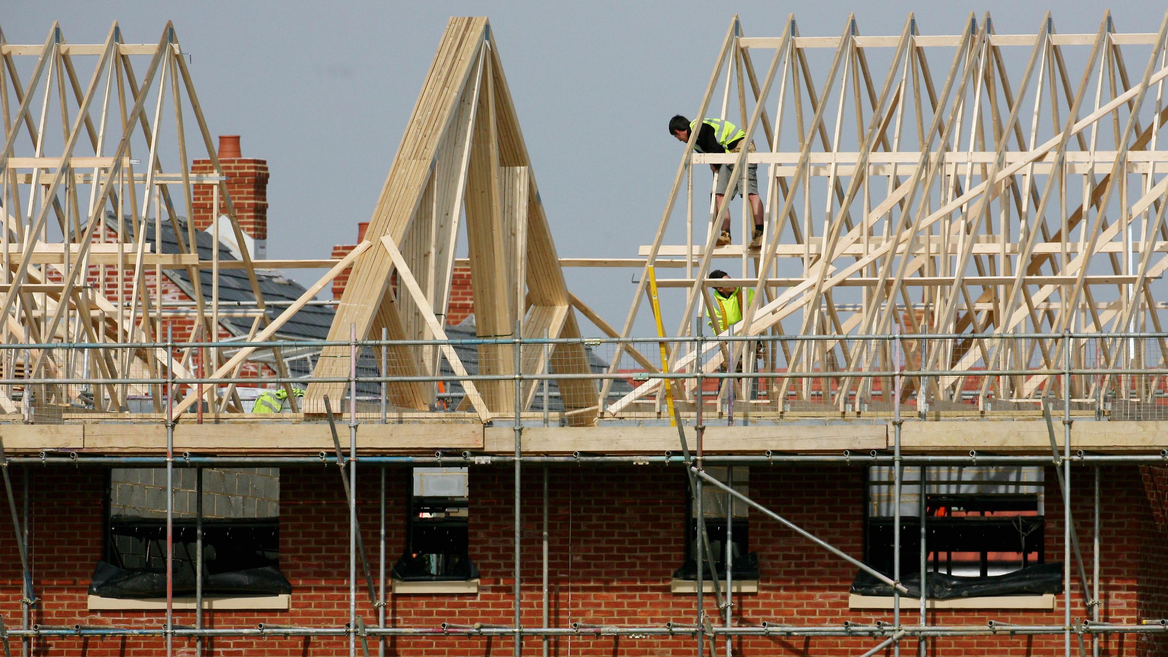 Builders at work on new homes.