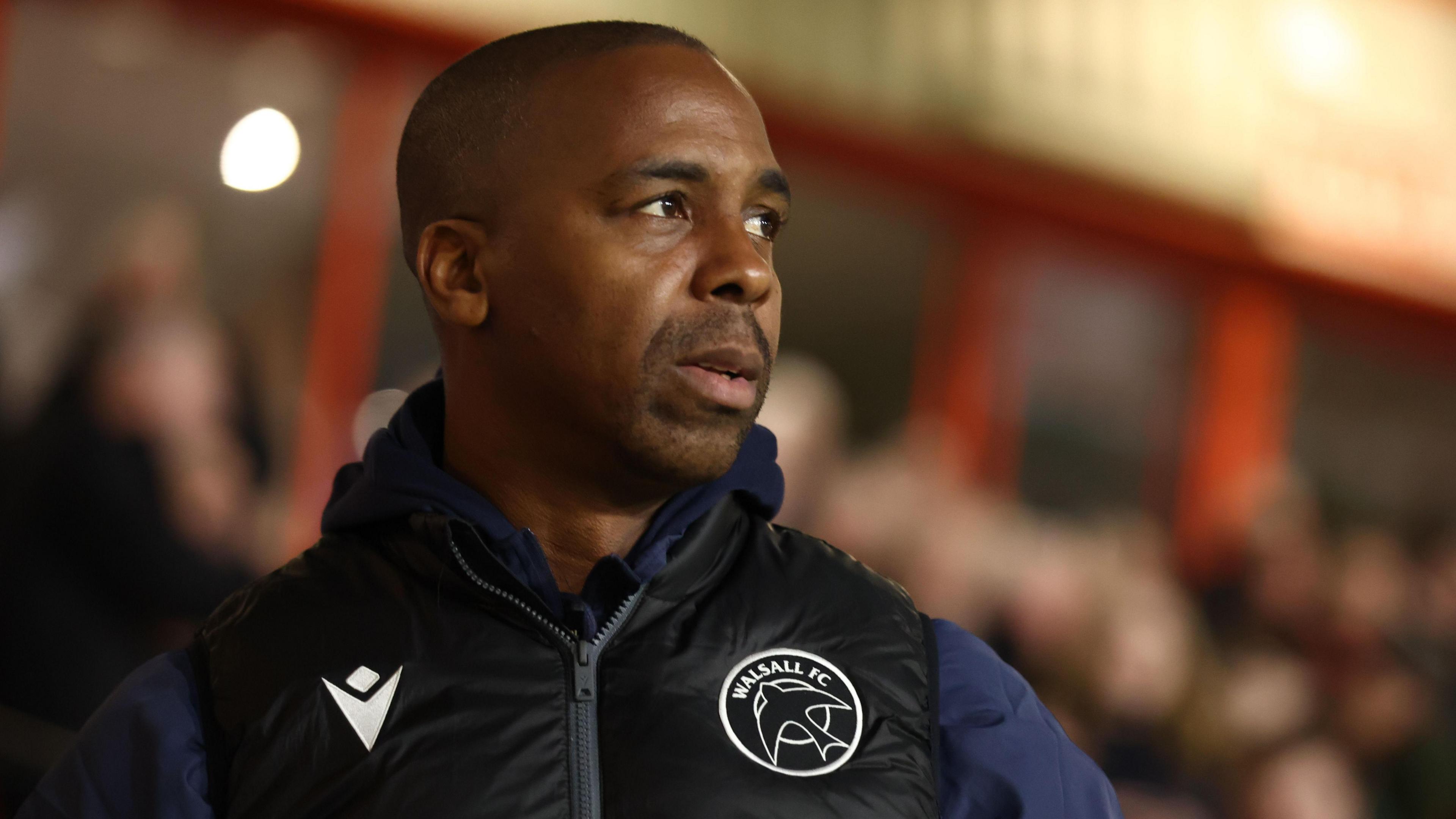Darren Byfield looks on from the touchline during a game 