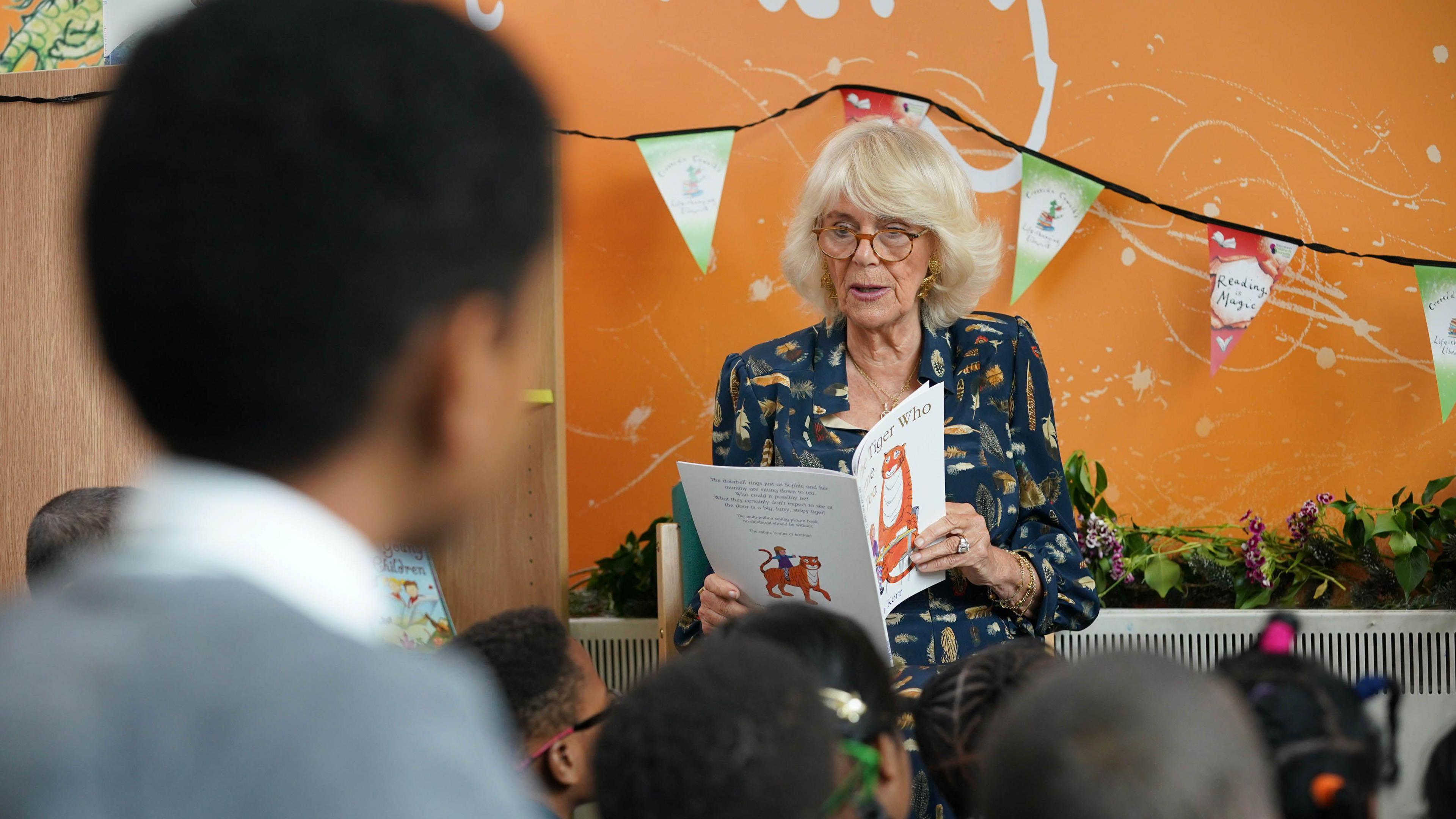 Queen Camilla reading The Tiger Who Came to Tea to a bunch of school children