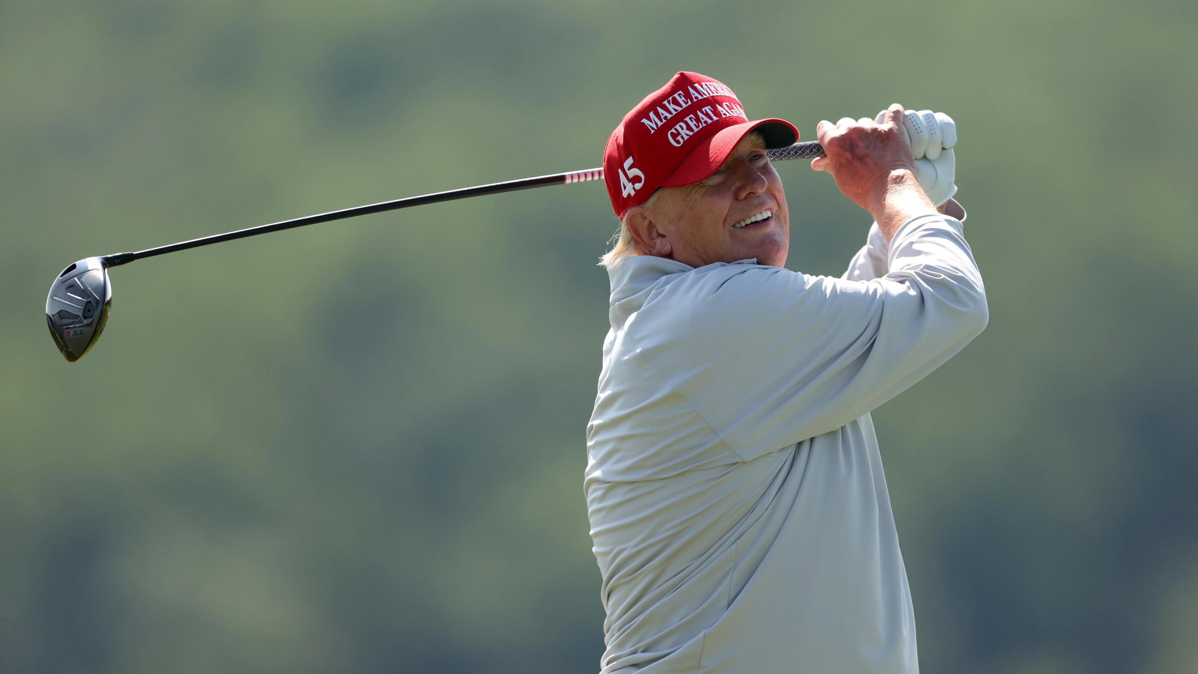 Donald Trump in the follow-through of a golf shot