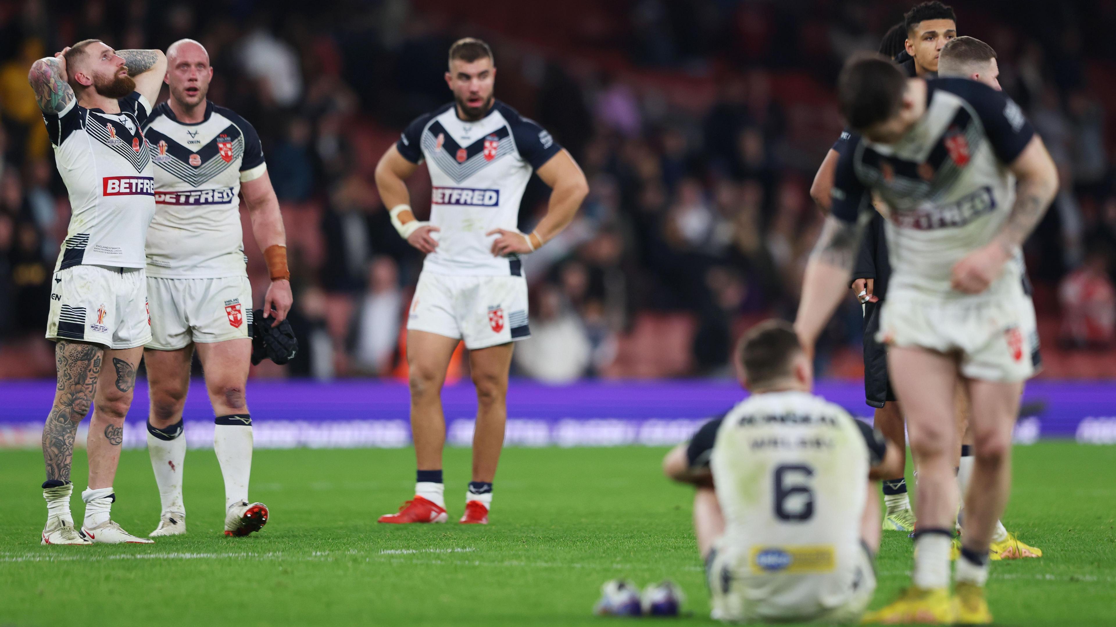 England players look dejected and disappointment as they take in their golden point World Cup semi-final loss to Samoa in 2022