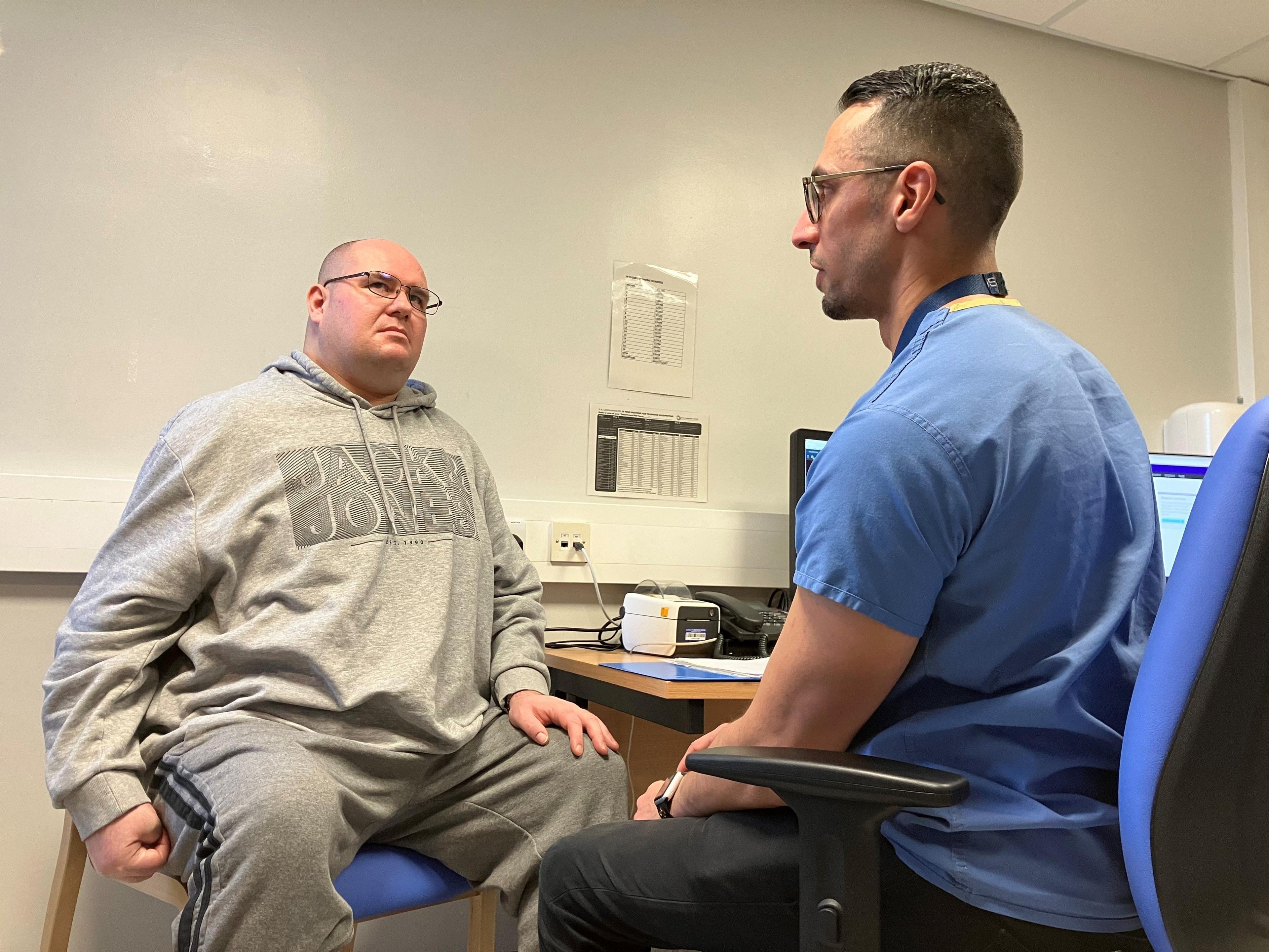 Stroke patient Roy, a participant in the trial, with consultant Dr Ali Ali