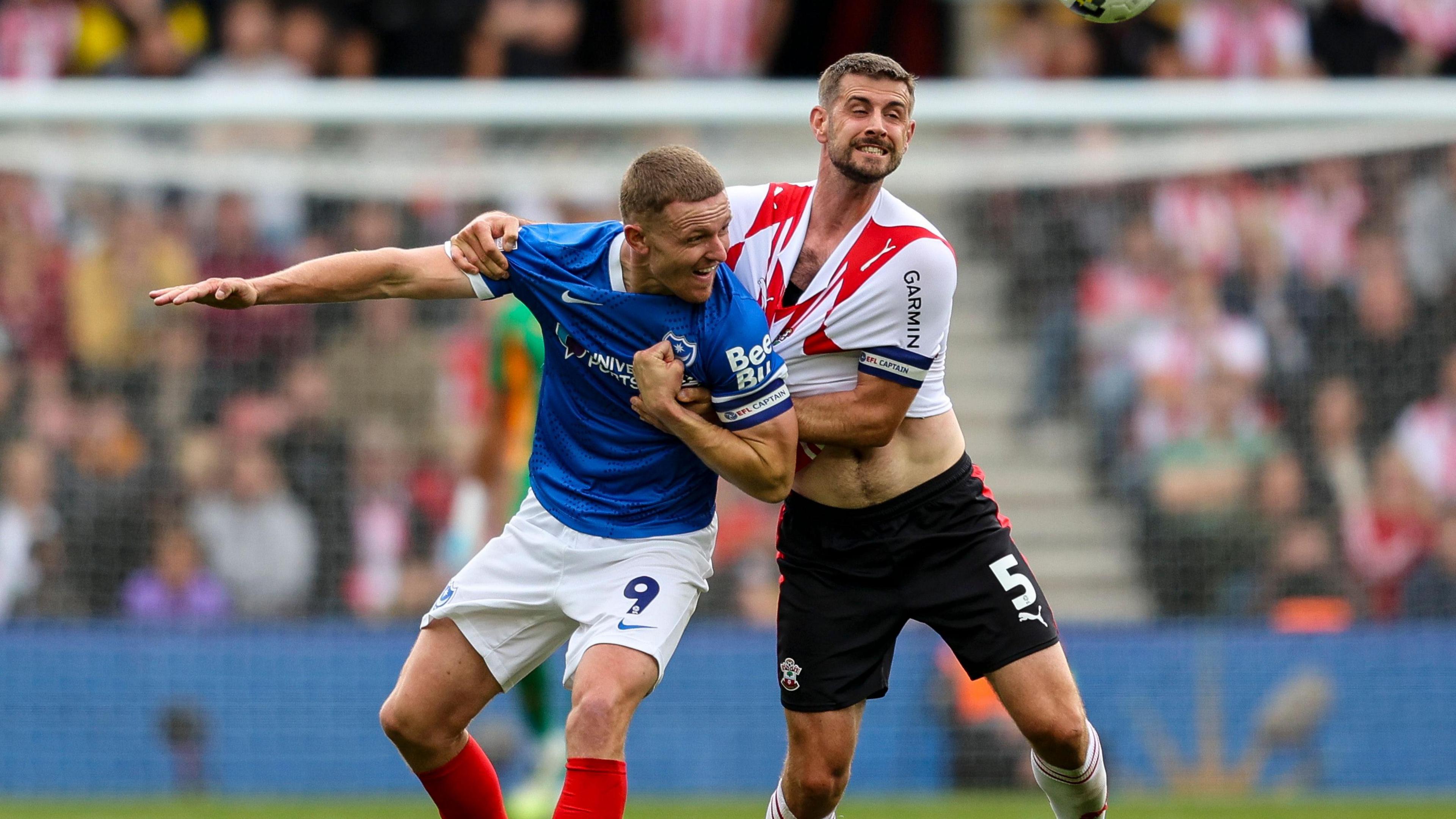 Portsmouth's Colby Bishop (left) and Southampton's Jack Stephens wrestle for possession of the ball in September's south coast derby