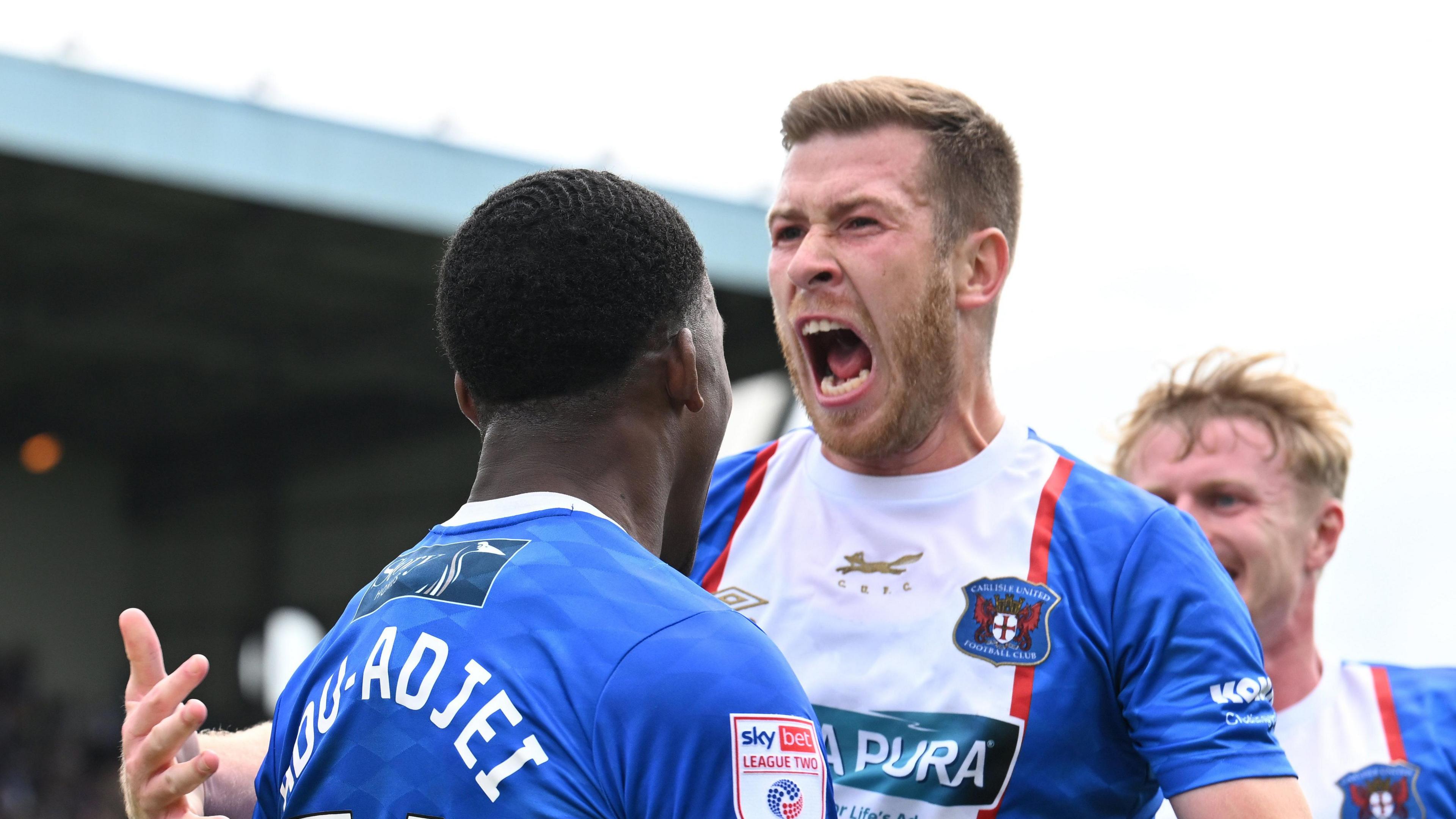 Carlisle players congratulate Dan Adu-Adjei for scoring in the derby at home to Barrow in August