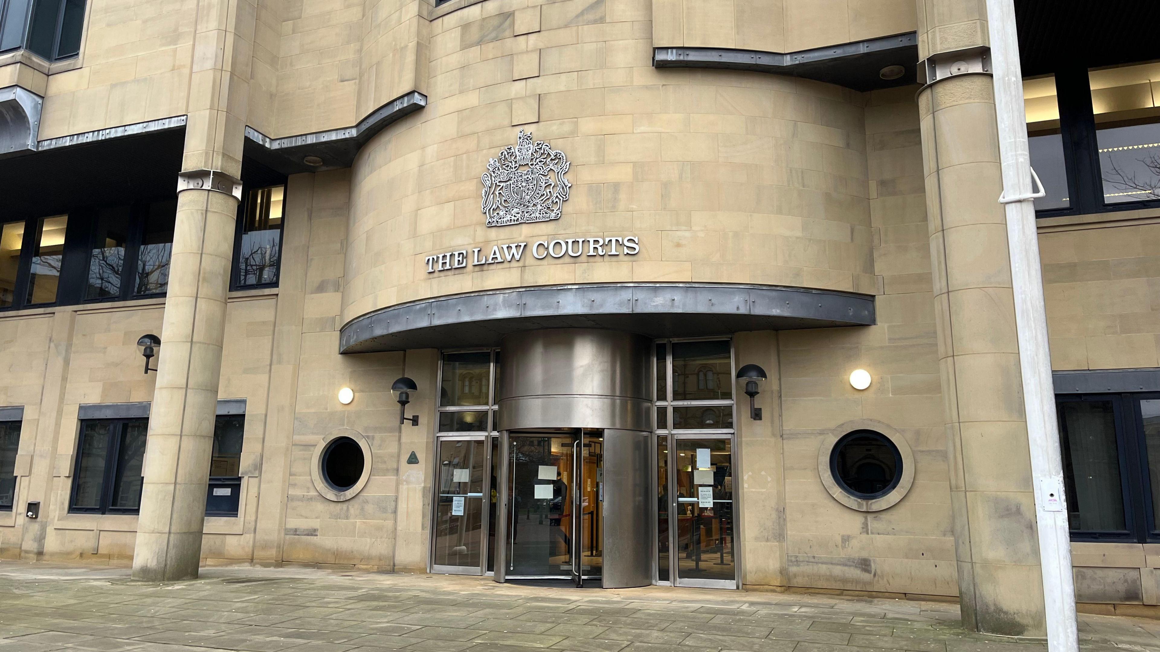 Bradford Crown Court, with a revolving door and lettering reading "The Law Courts" above the door.