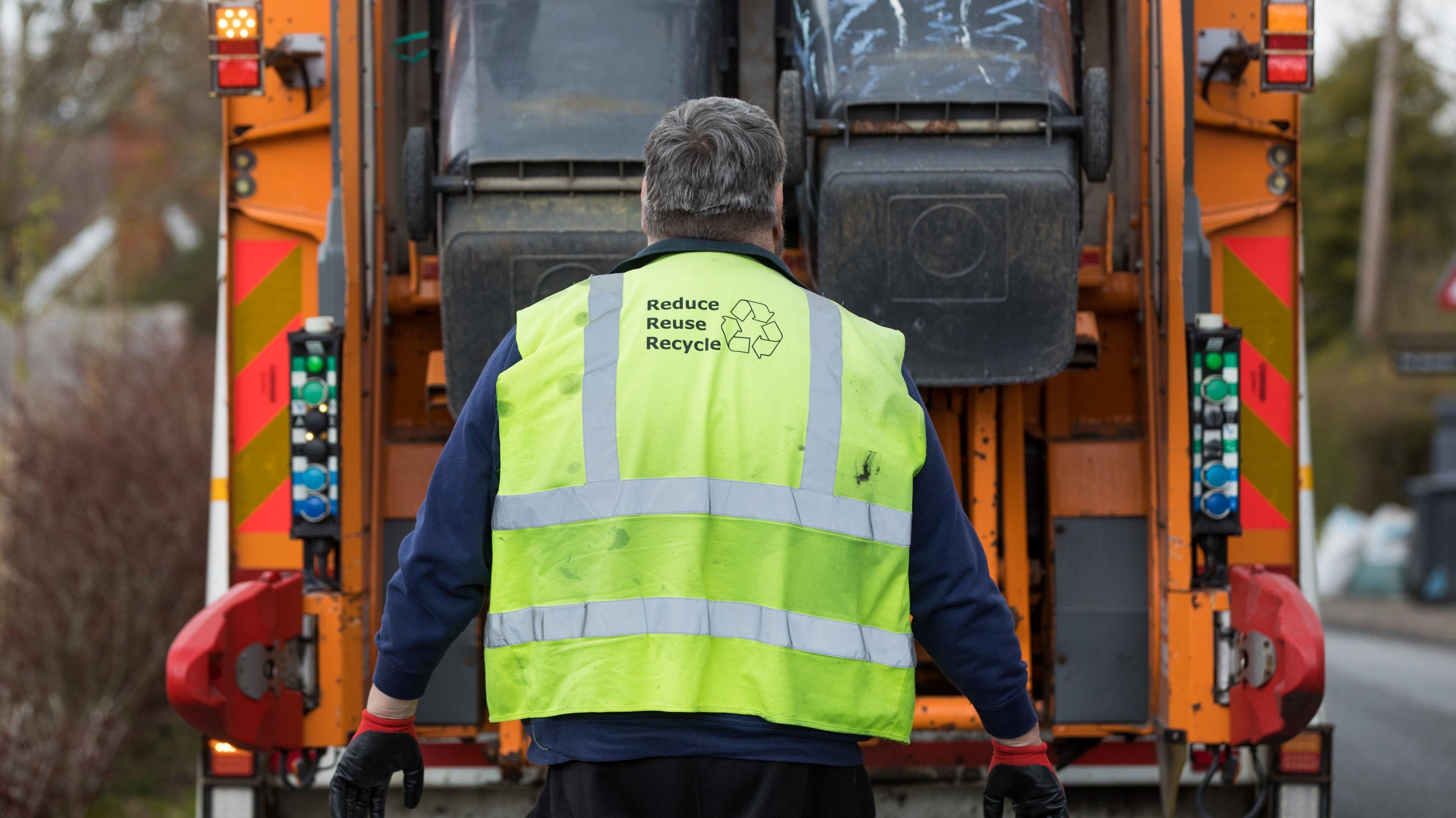 Bin lorry and worker in a hi-vis council vest