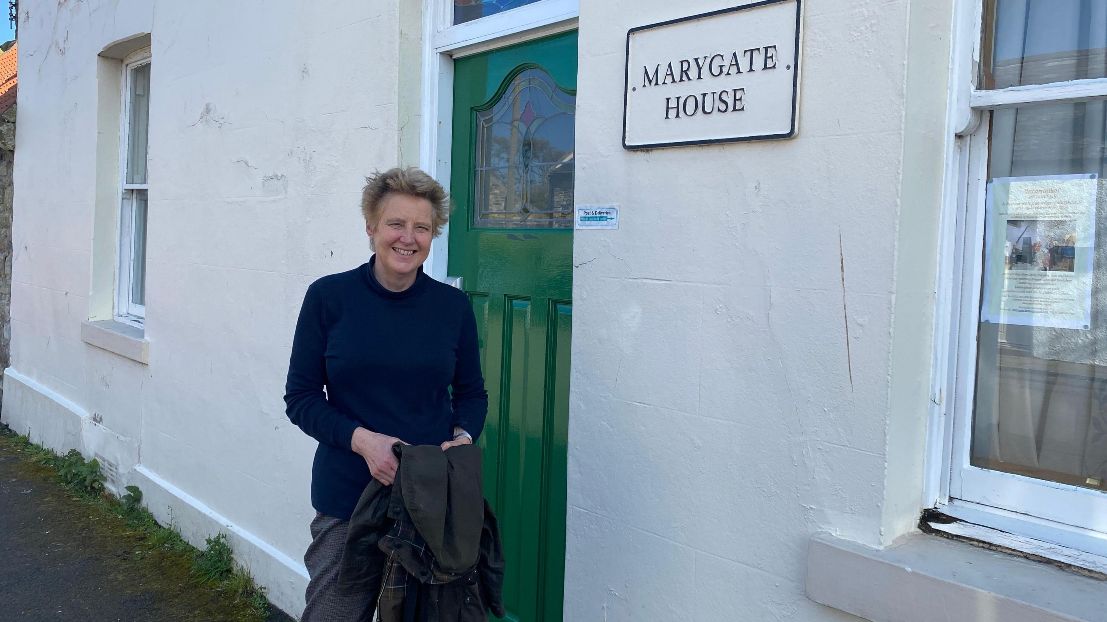 The warden of Marygate House at its entrance