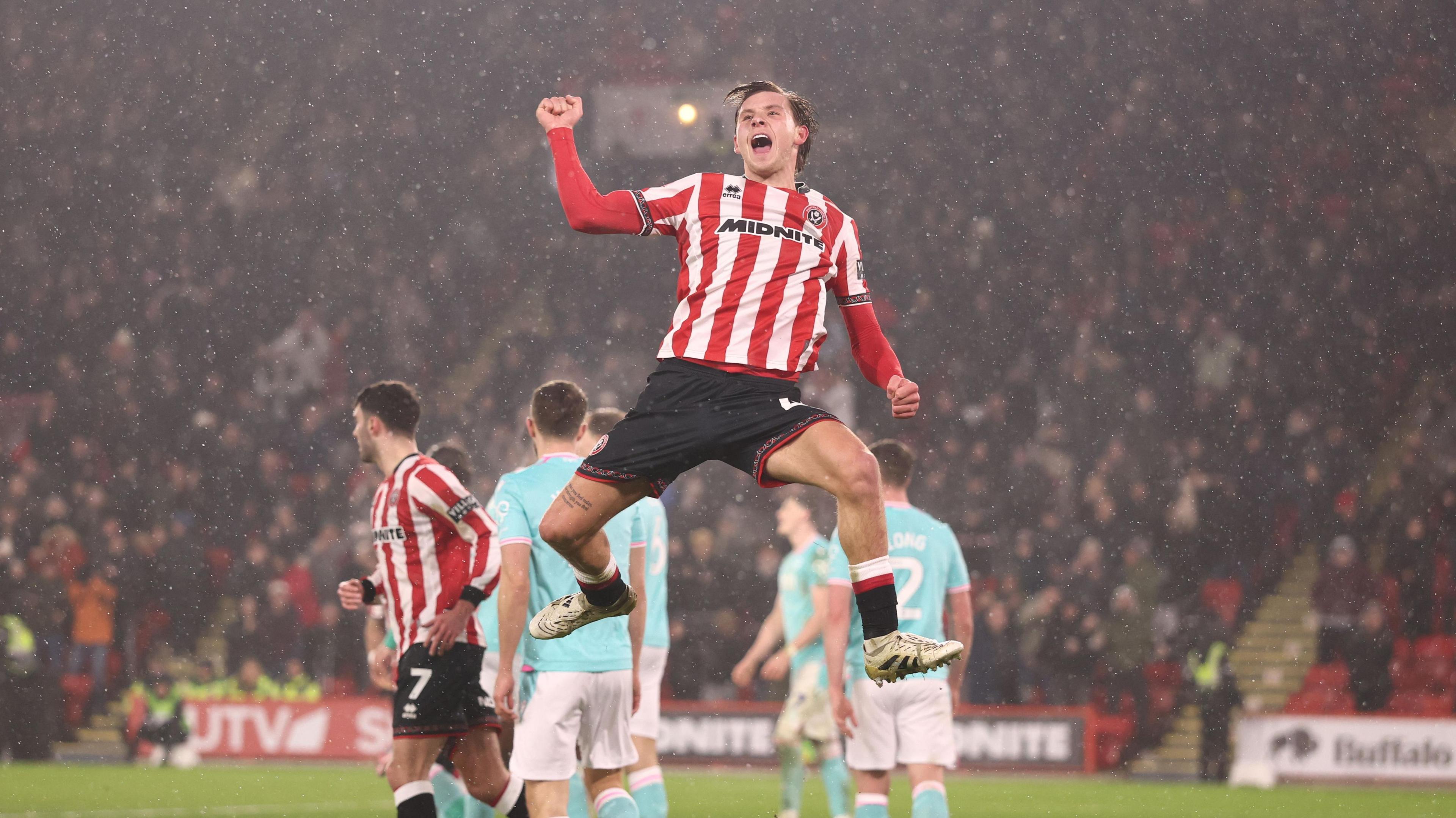 Sydie Peck jumps into the air to celebrate his first half equaliser for Sheffield United
