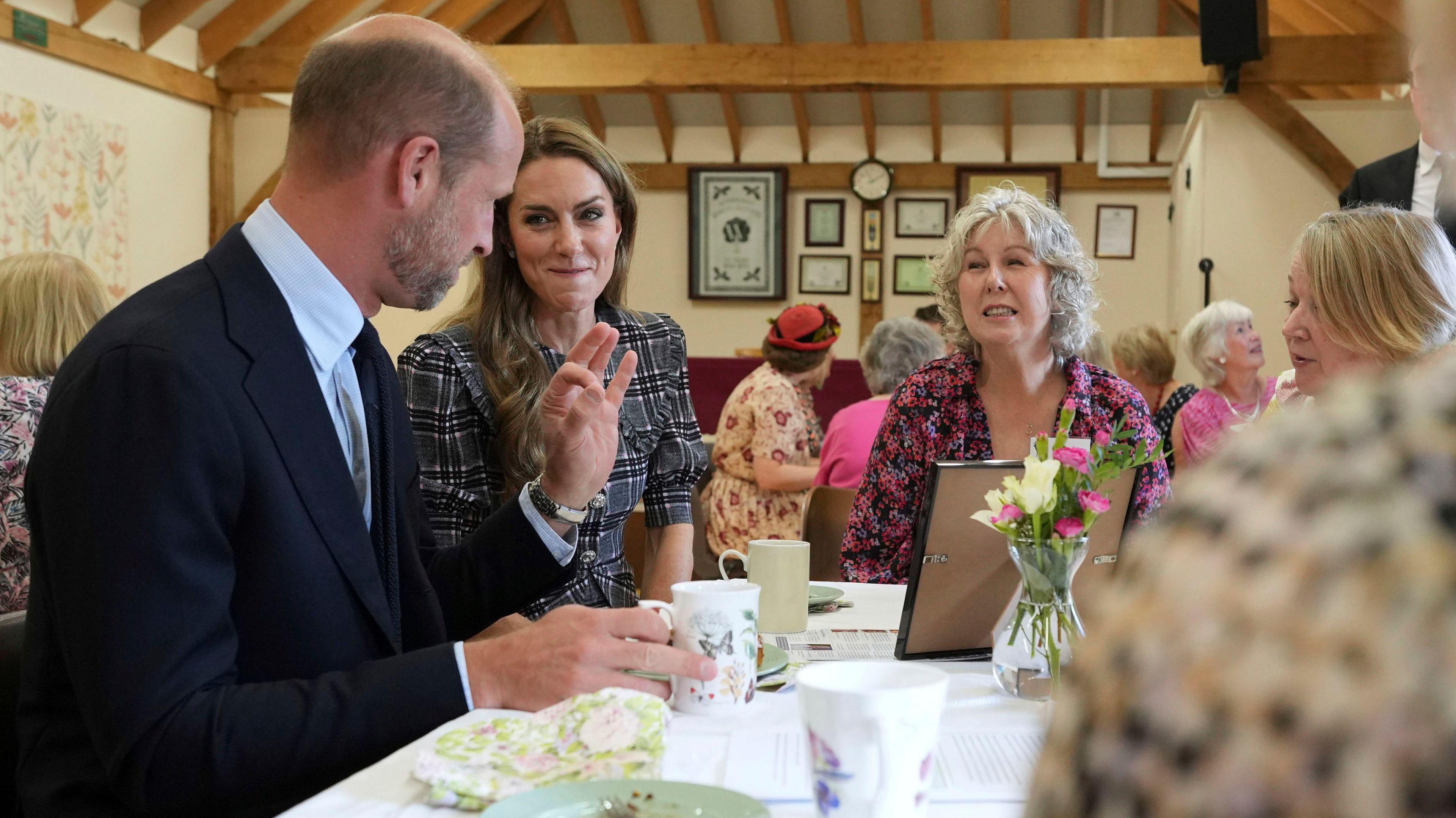 The Prince and Princess of Wales speak to members during a visit to the National Federation of Women's Institute (WI) in Sunningdale, Berkshire, to mark the third anniversary Queen Elizabeth II's death