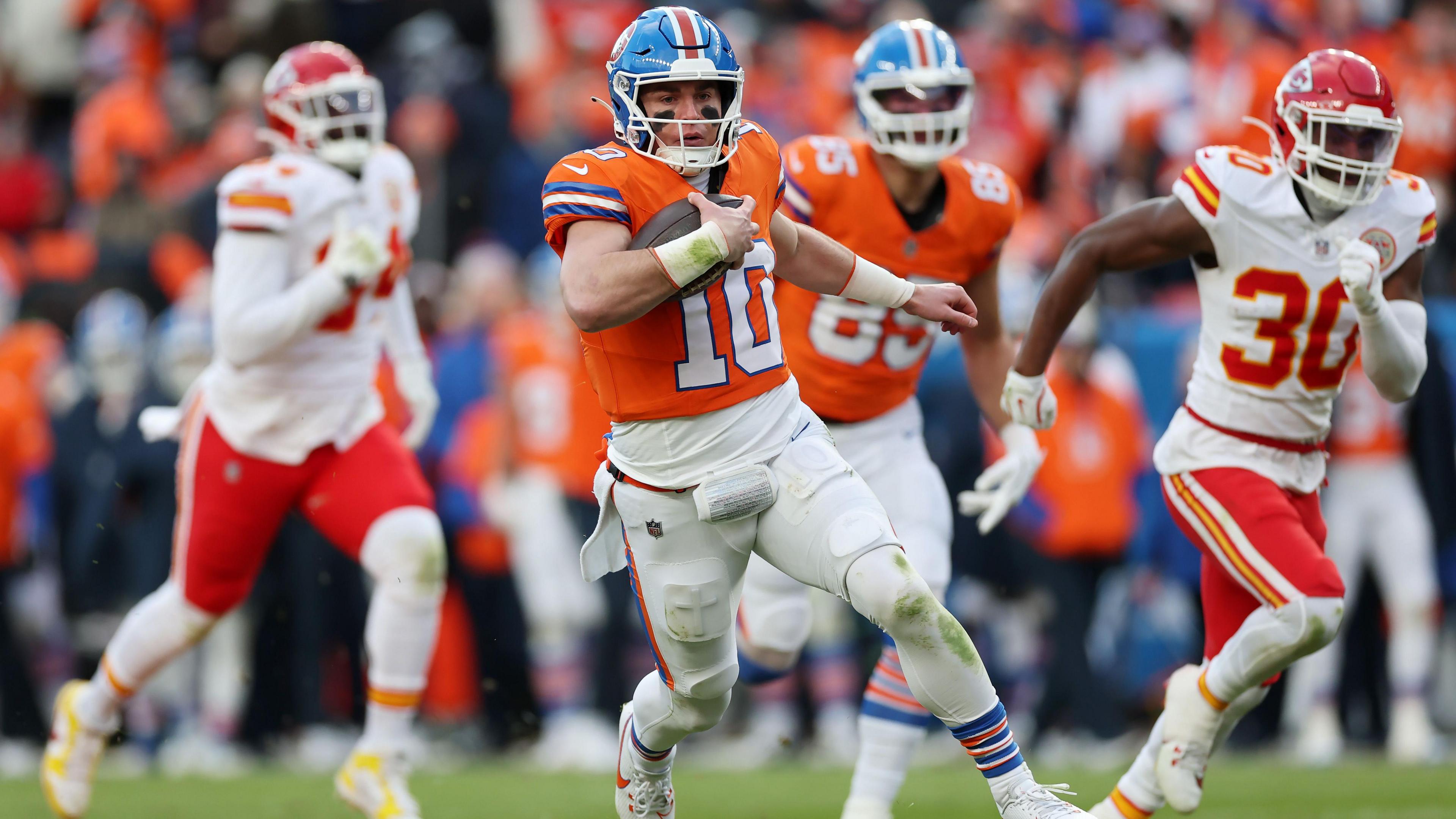 Denver Broncos quarterback Bo Nix running with the ball against the Kansas City Chiefs