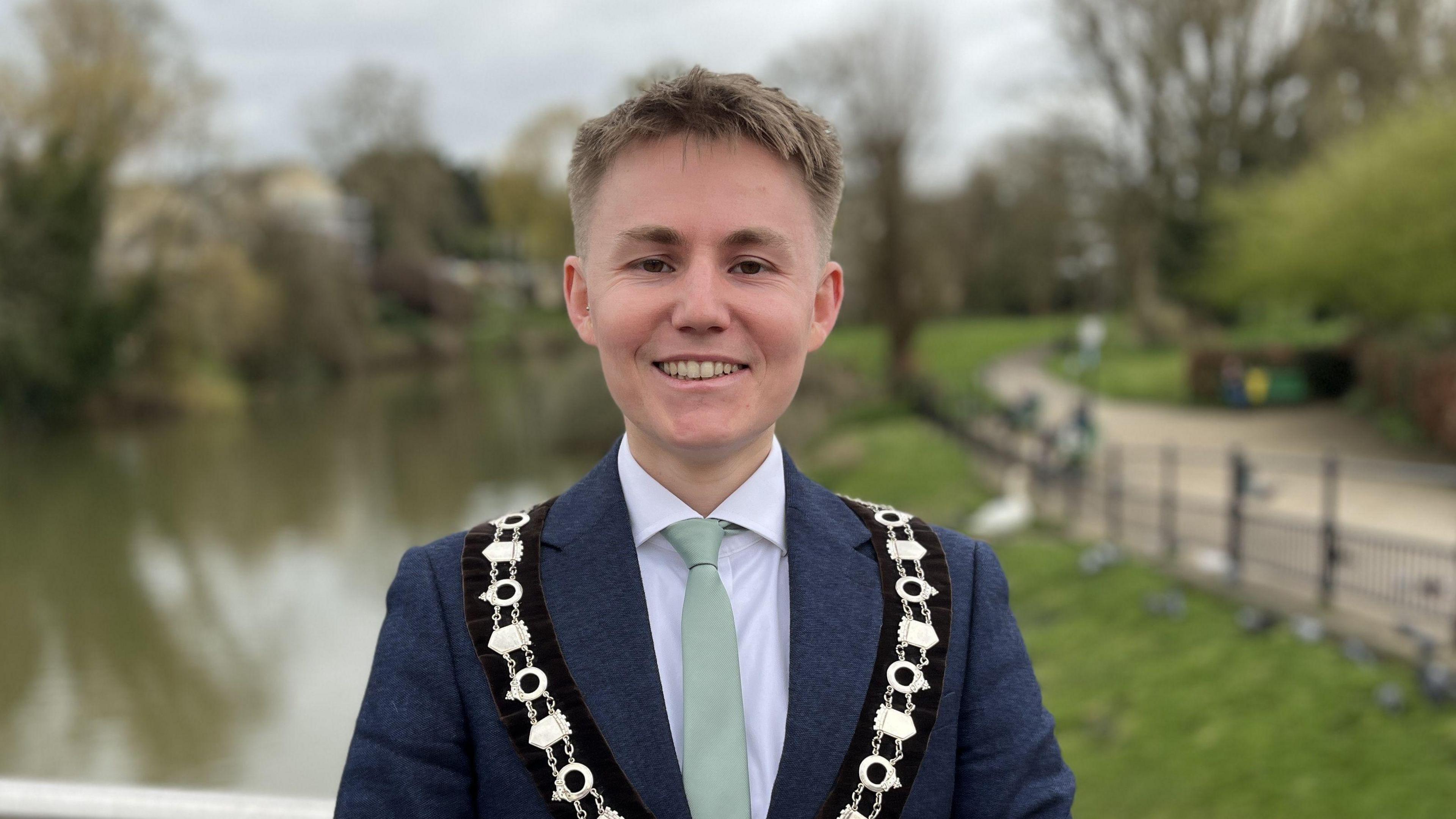 Declan Baseley, Chippenham's Mayor wearing a blur suit, green tie and his mayoral chain