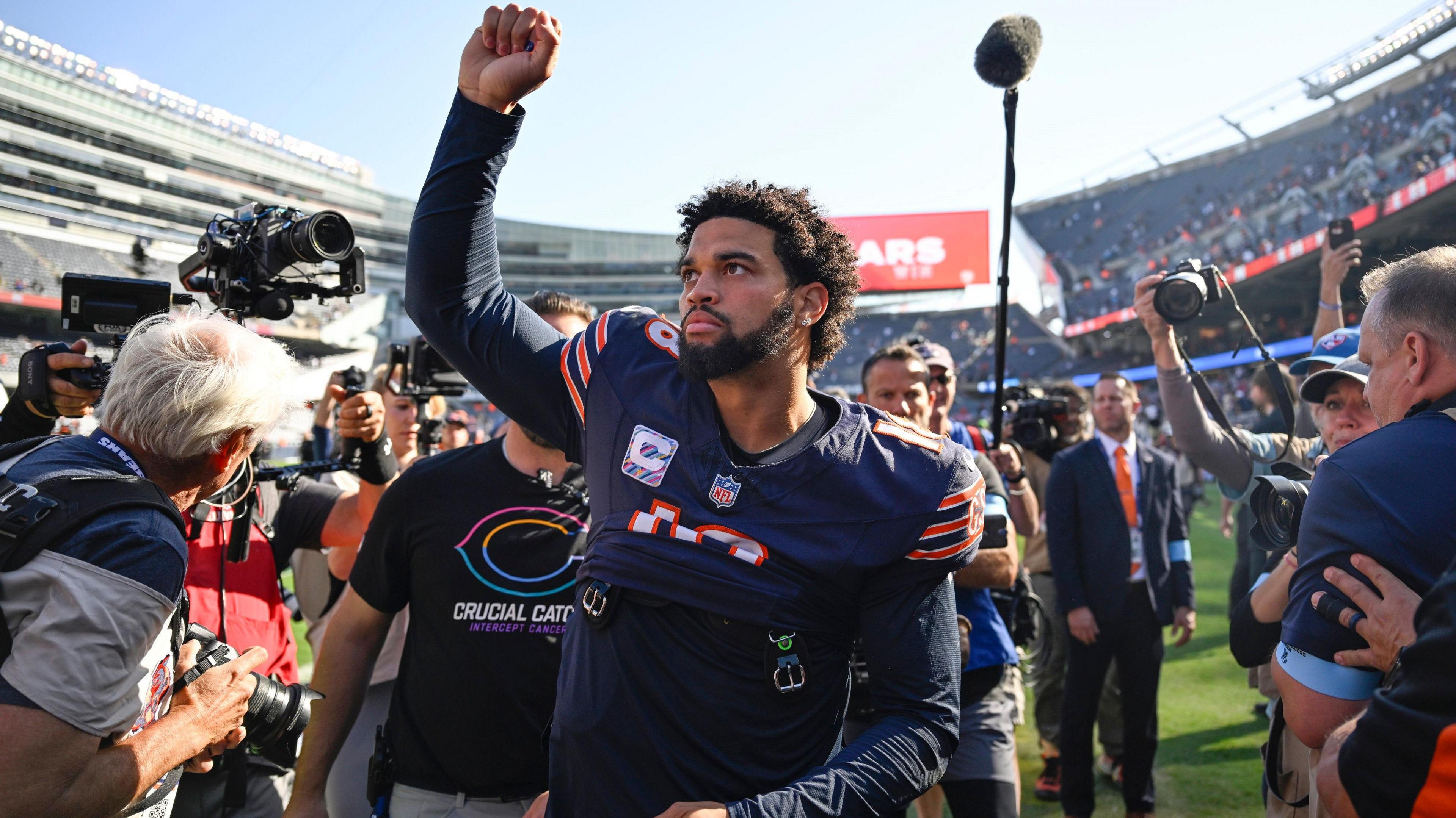 Chicago Bears quarterback Caleb Williams salutes the crowd after victory