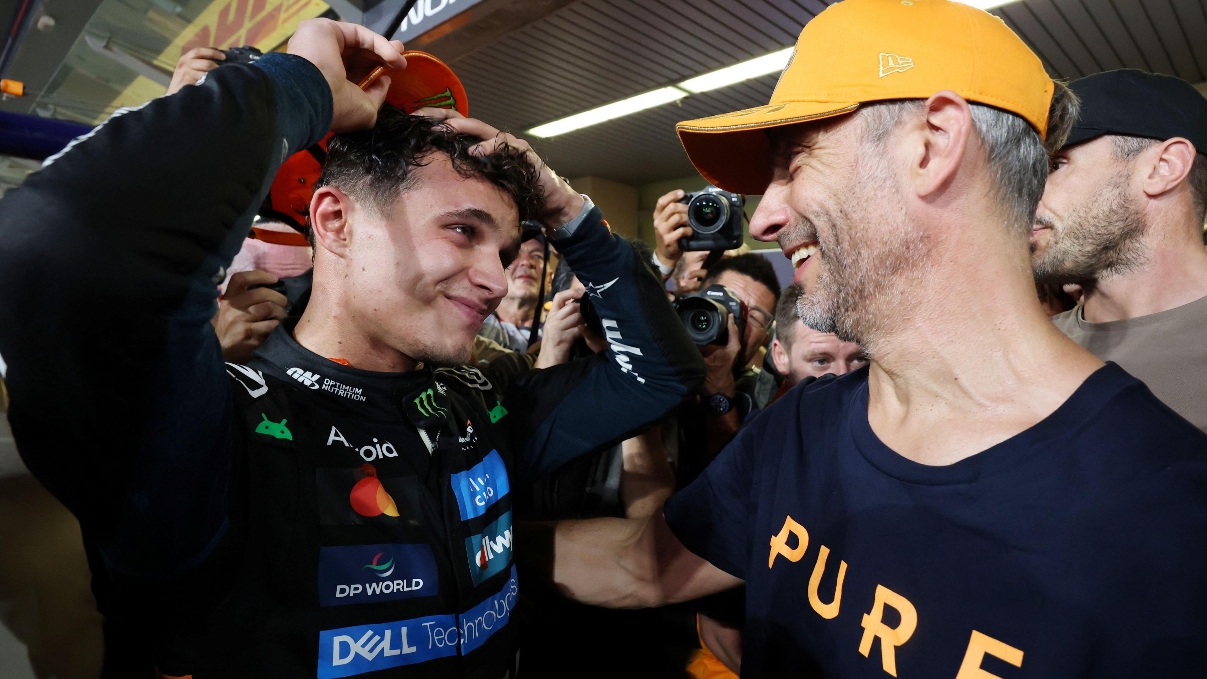 Adam Norris congratulates his son Lando after he won the 2025 F1 drivers' championship at the Abu Dhabi Grand Prix