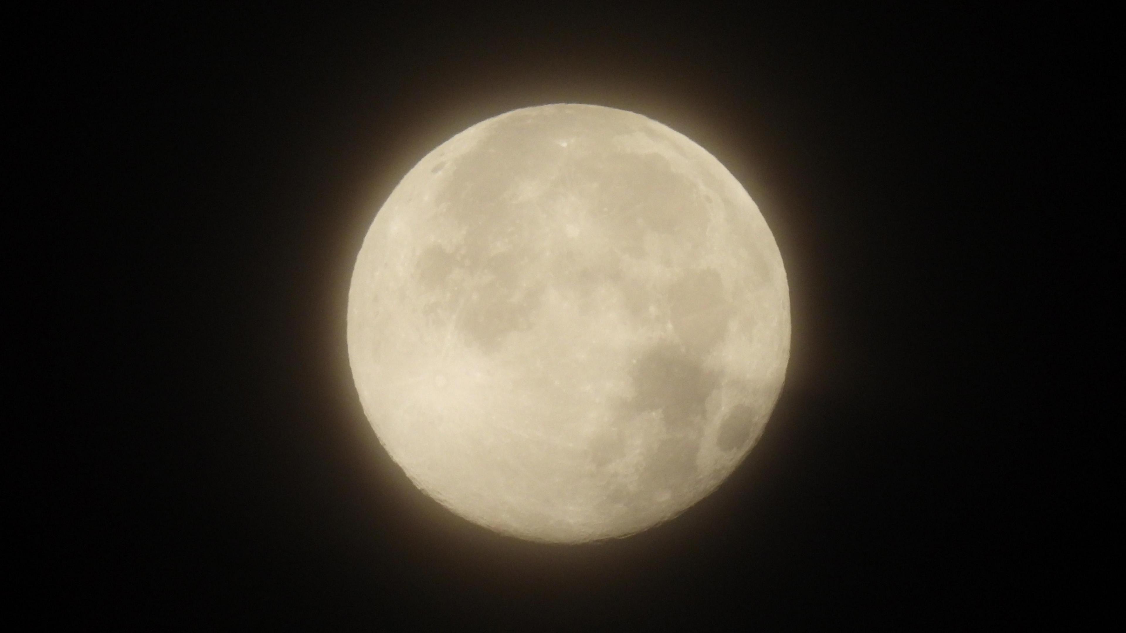 A close up of the moon with craters visible.