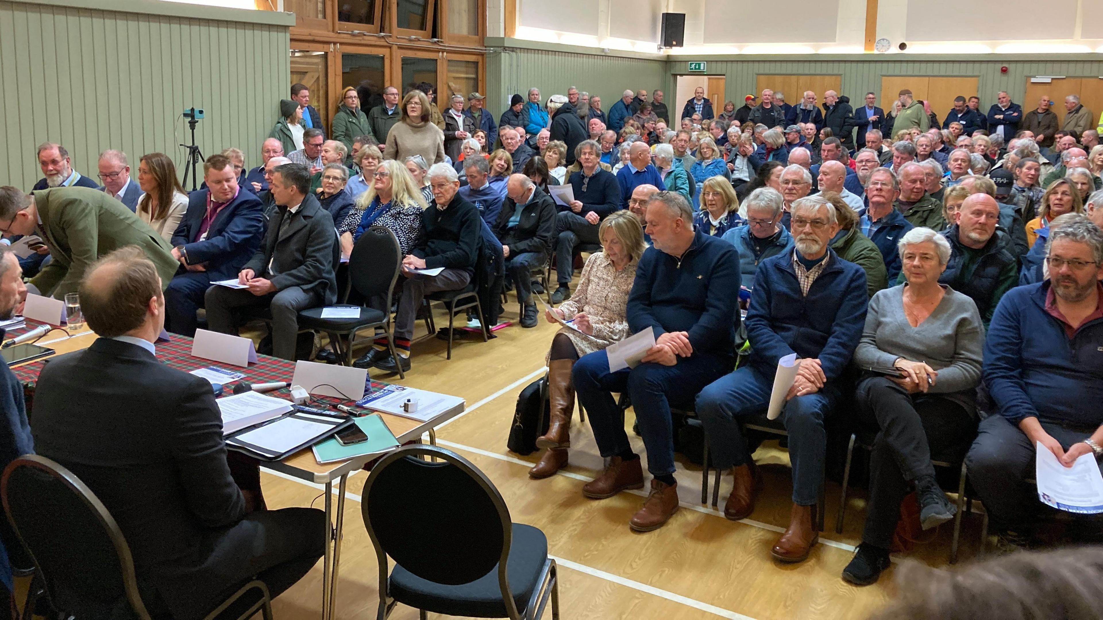 People sat at a village hall