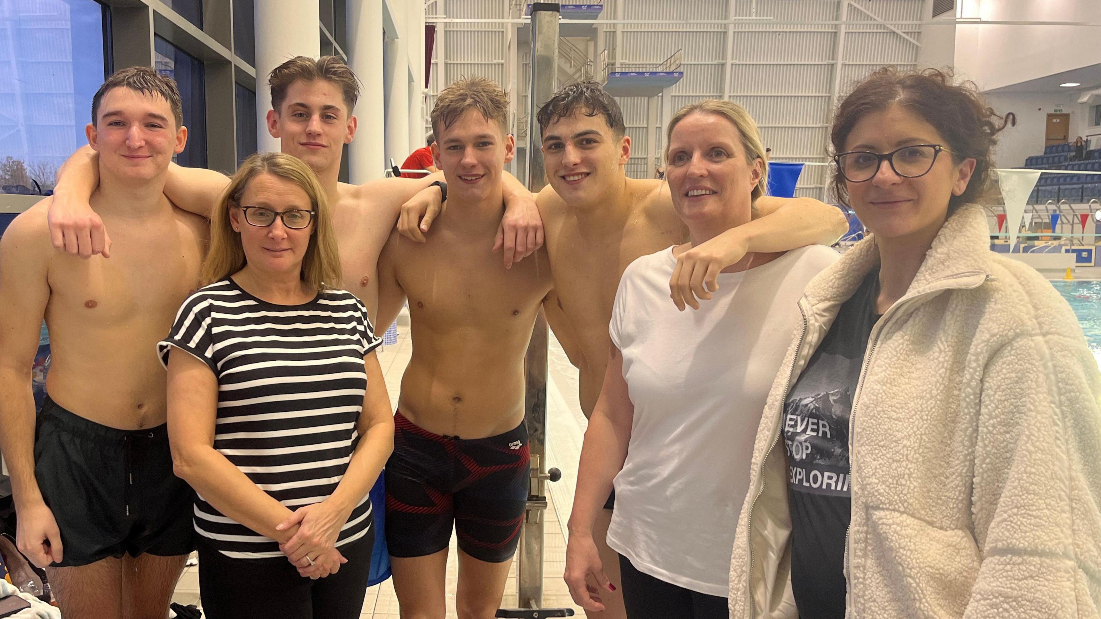 The FitzWimarc School pupils George Coverly, 17, George Nagle, 17, Jack Minney, 17 and Henry Dean, 18, with teacher Manjola Carter and parents after completing a swim the distance equivalent to the English Channel at Southend Leisure & Tennis centre on Thursday 28th November 2024