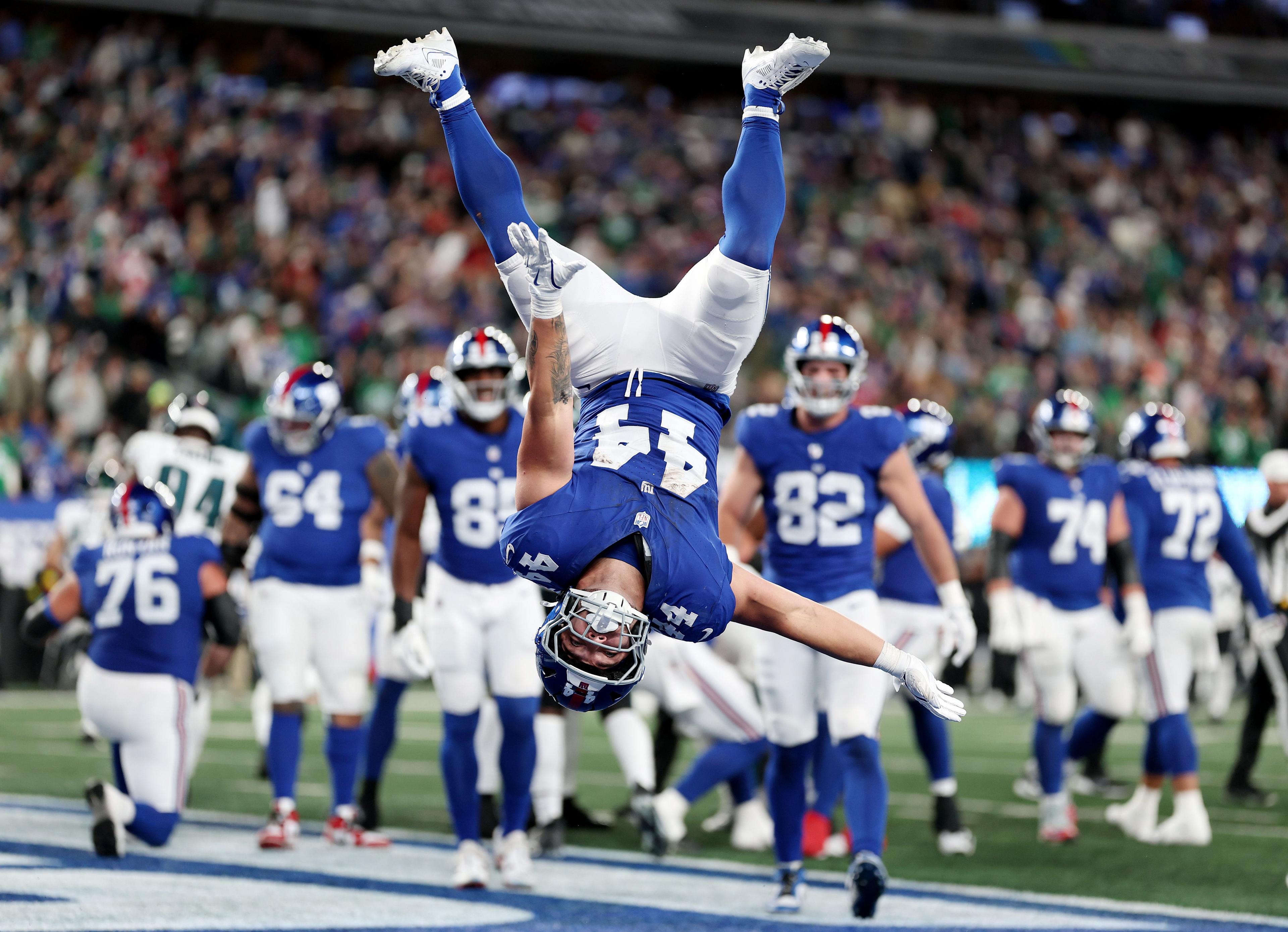 New York Giants' Cam Skattebo performs a somersault to celebrate a touchdown against the Philadelphia Eagles in the NFL