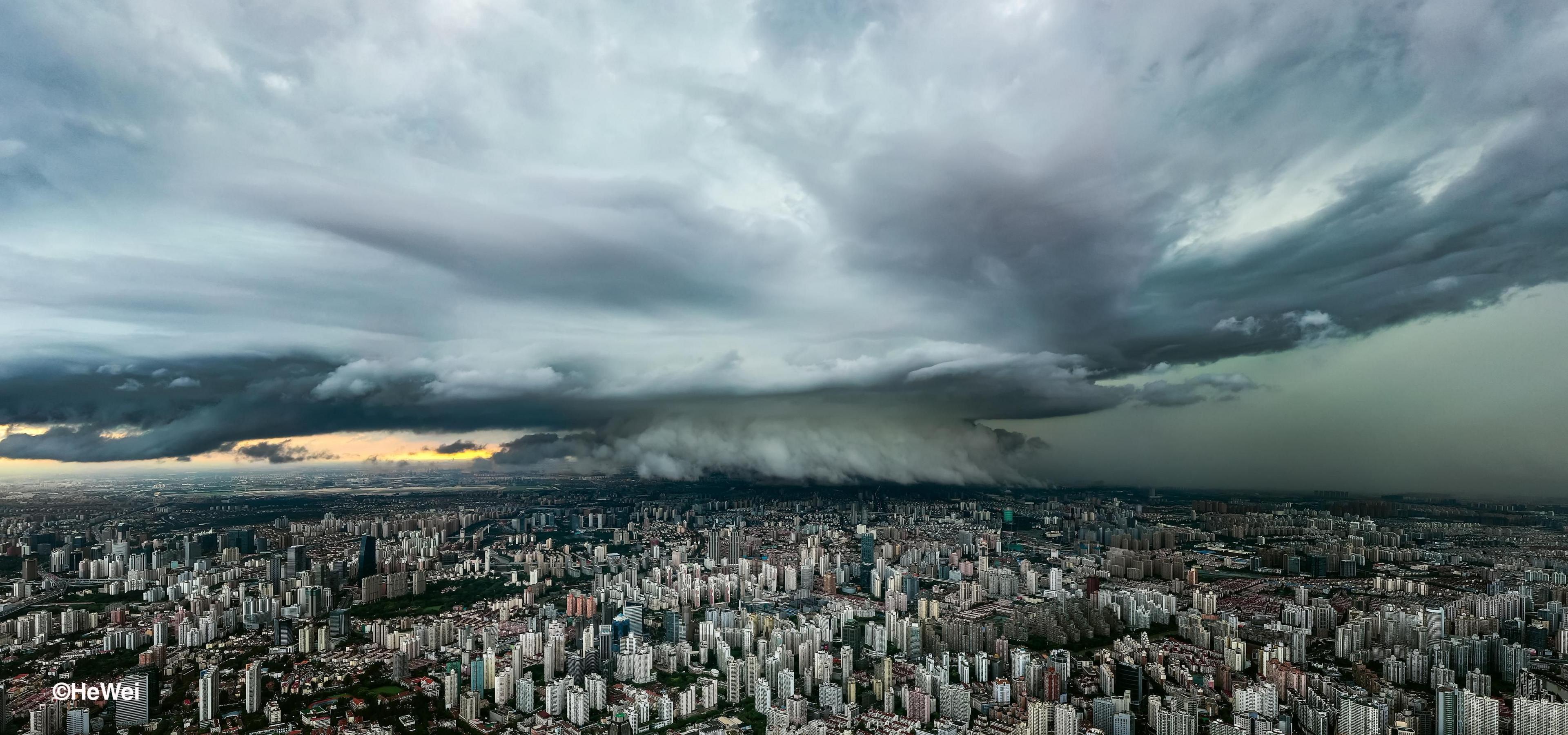 a dramatic photo of a huge storm cloud, called a supercell, hanging over Shanghai in China.