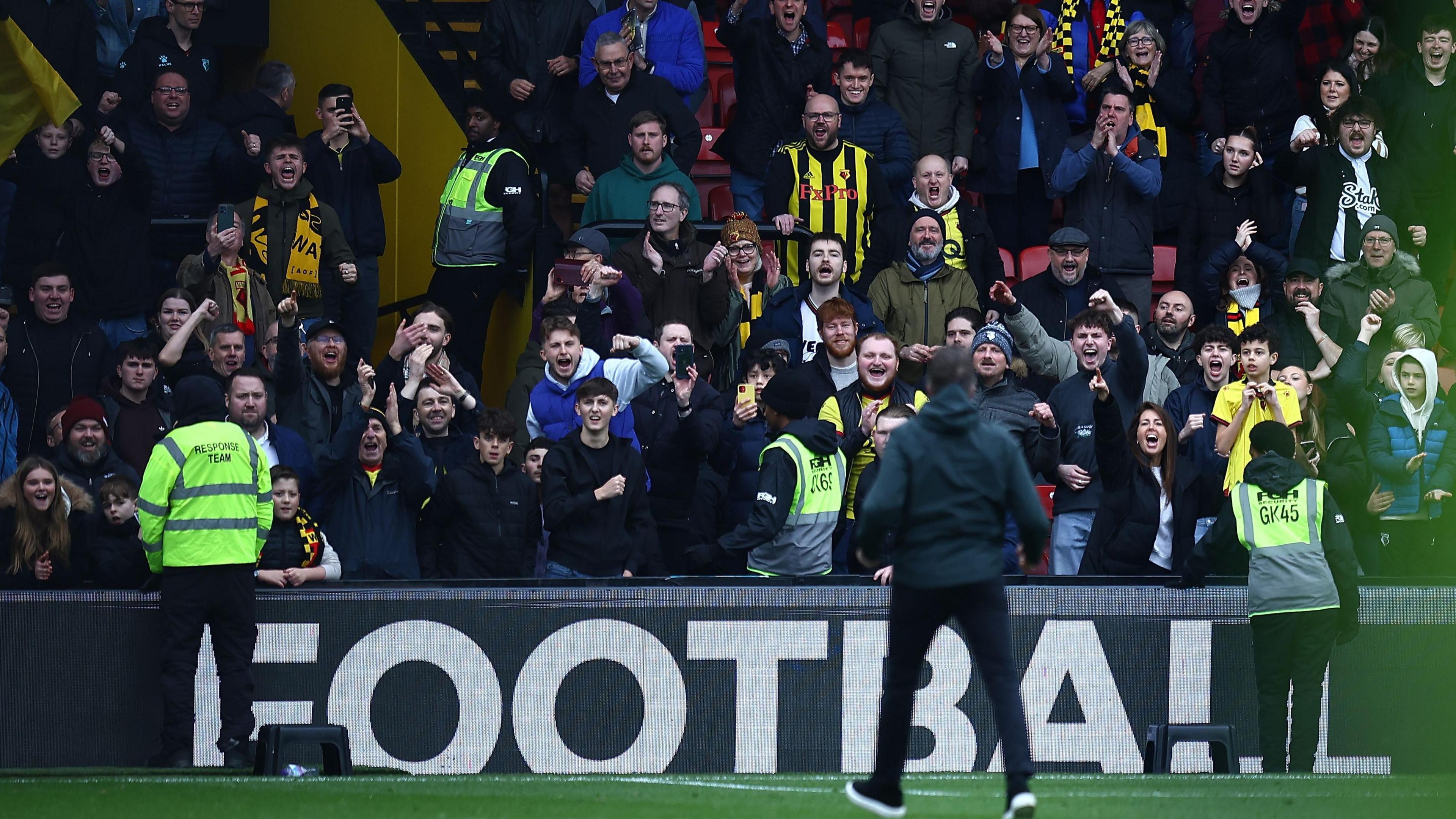 Watford fans celebrate with Tom Cleverley after a win over Luton in February