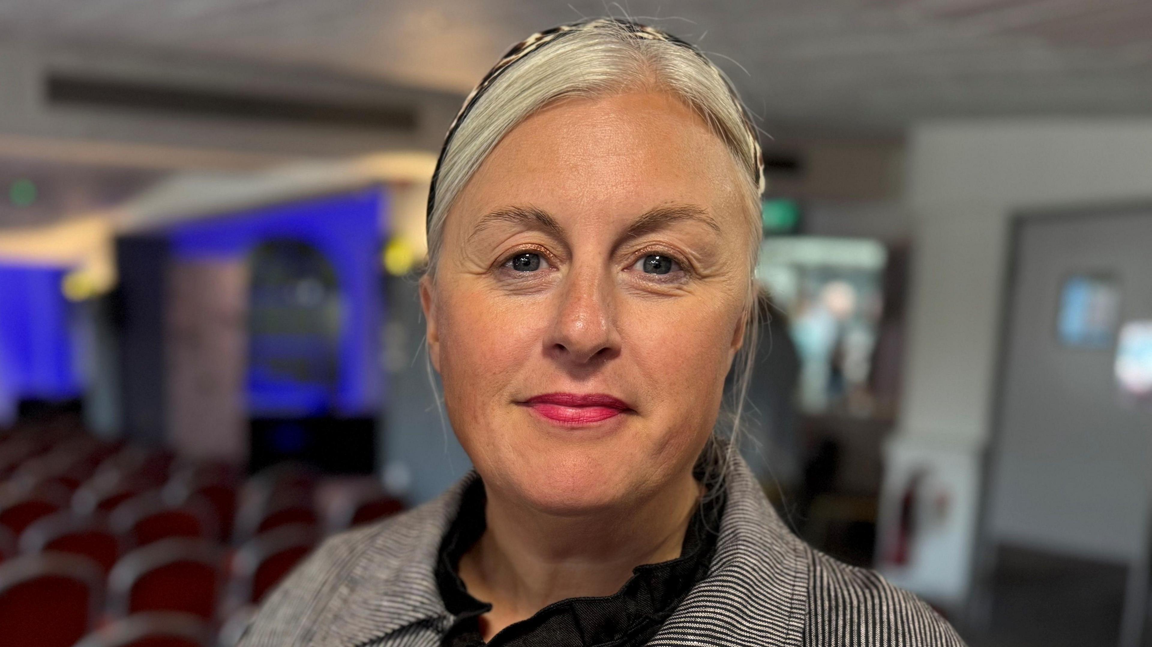 Woman with blonde hair looking at camera